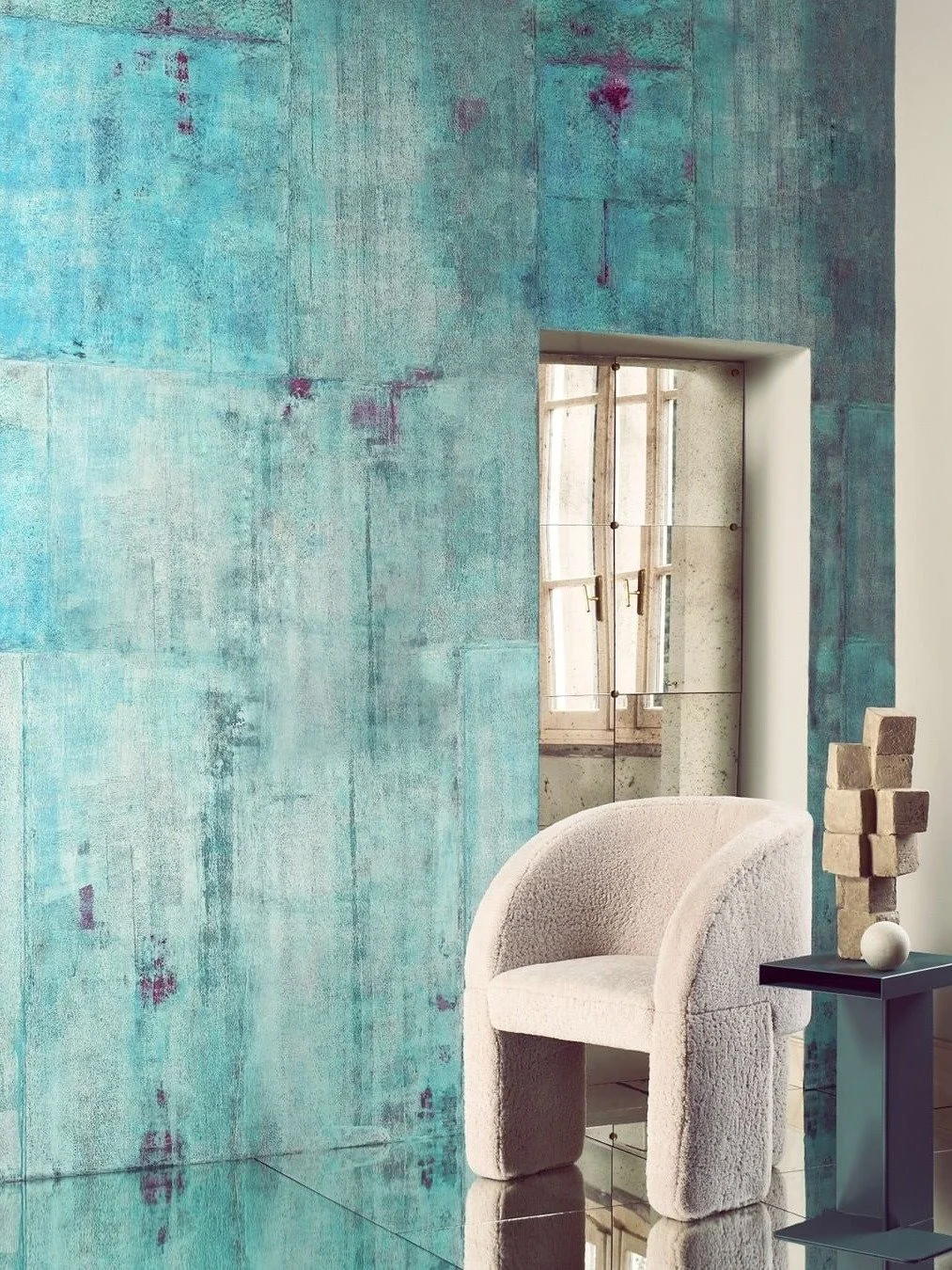 This is copper after time gets to it.

Verderame Wall Painting starts with a copper base and oxidizes from there, producing the blue-green verdigris you see here, and those flashes of deep magenta where the original copper tone bleeds through. It's a