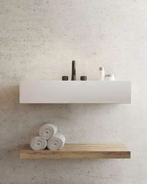 Walls that looks like they were cut from stone and are actually troweled lime plaster. That is Teodorico.

It is a lime-based finish with gold, silver and bronze effects built into it, so the surface has that natural variation you see in travertine a