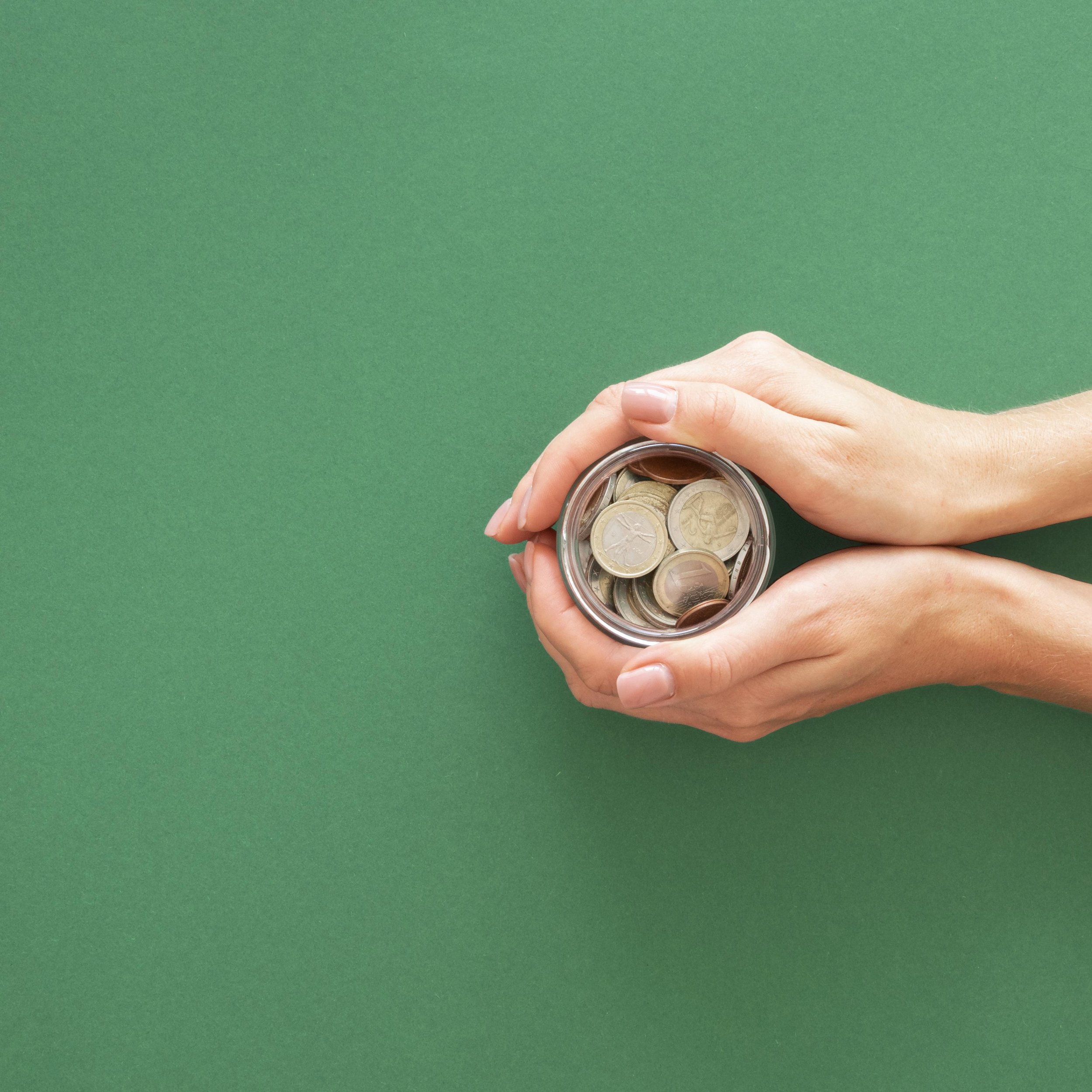 person-holding-jar-with-coins-with-copy-space.jpg