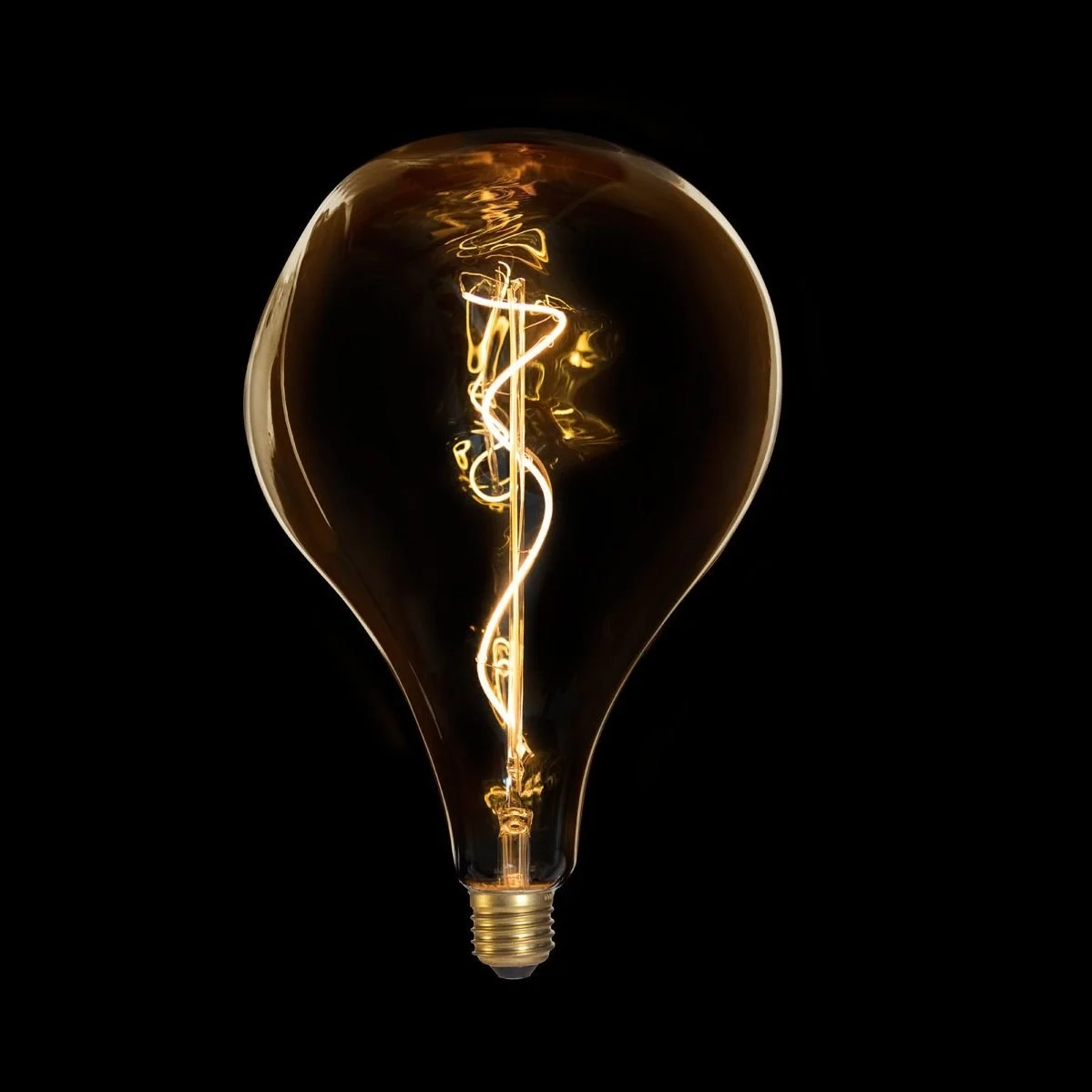 A glowing incandescent light bulb with a visible filament against a black background.