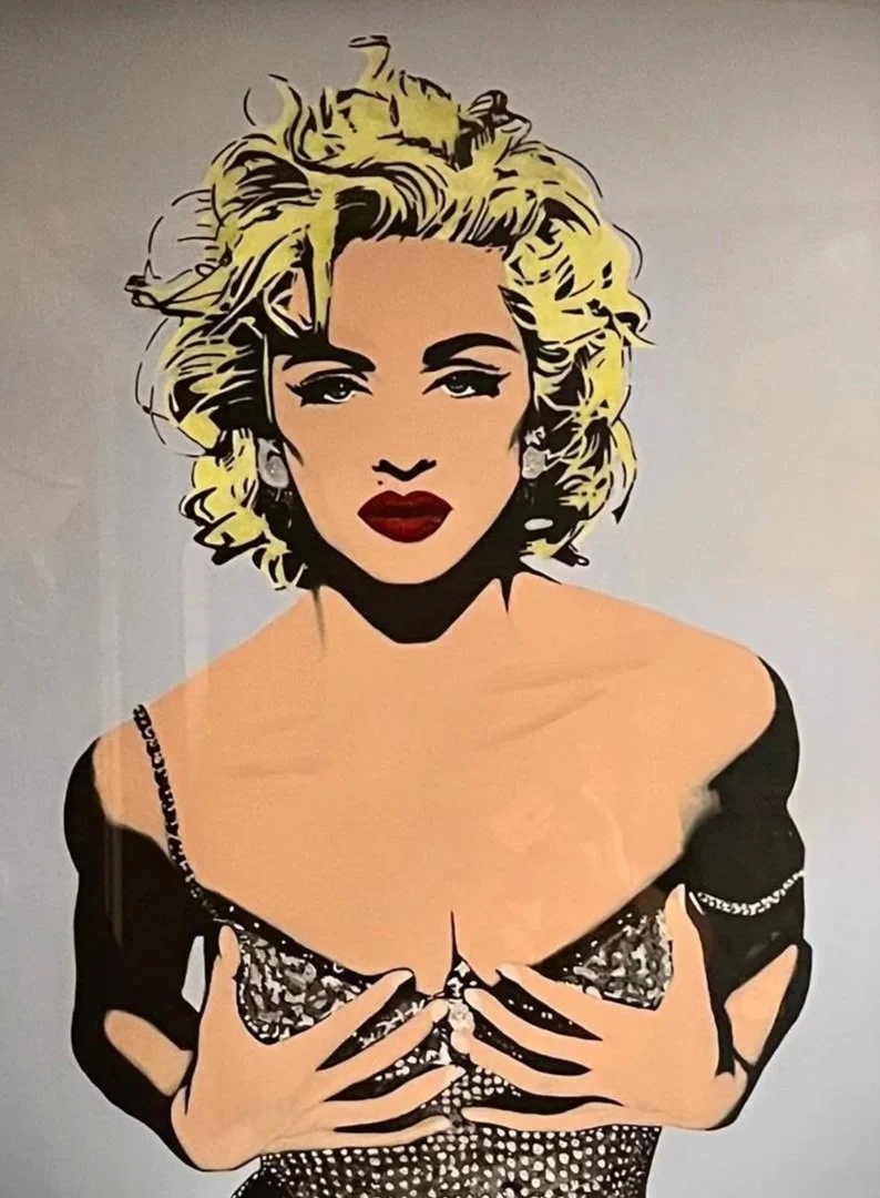 Pop art style illustration of a woman with blonde, curly hair, red lips, and wearing a black dress with a deep neckline, holding her breasts with both hands.