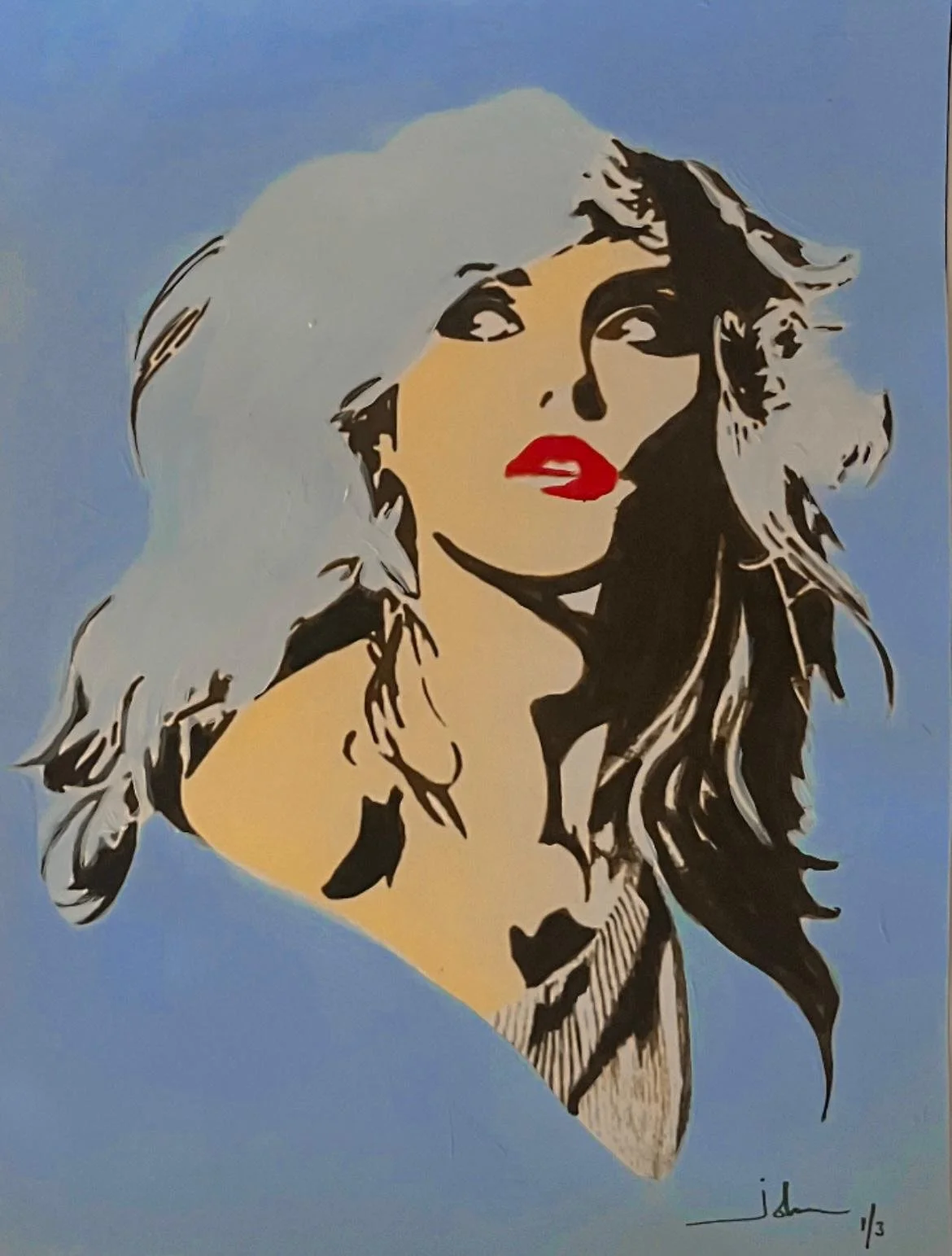 Pop art style image of a woman with blonde hair, red lips, and black and beige shading, set against a blue background.
