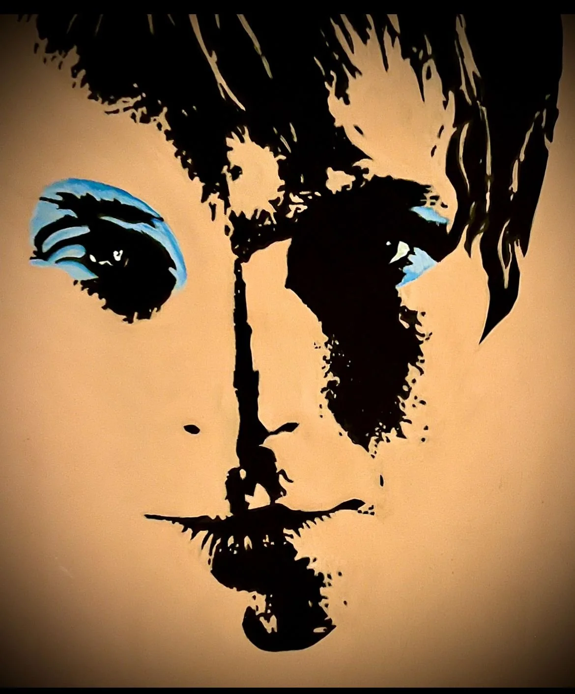 Stencil-style portrait of a child's face with blue eyes and long hair, with a reflection of the face below.