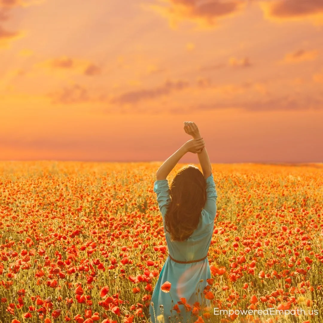 Woman in poppy field experiencing freedom and joy after recovering from narcissistic abuse