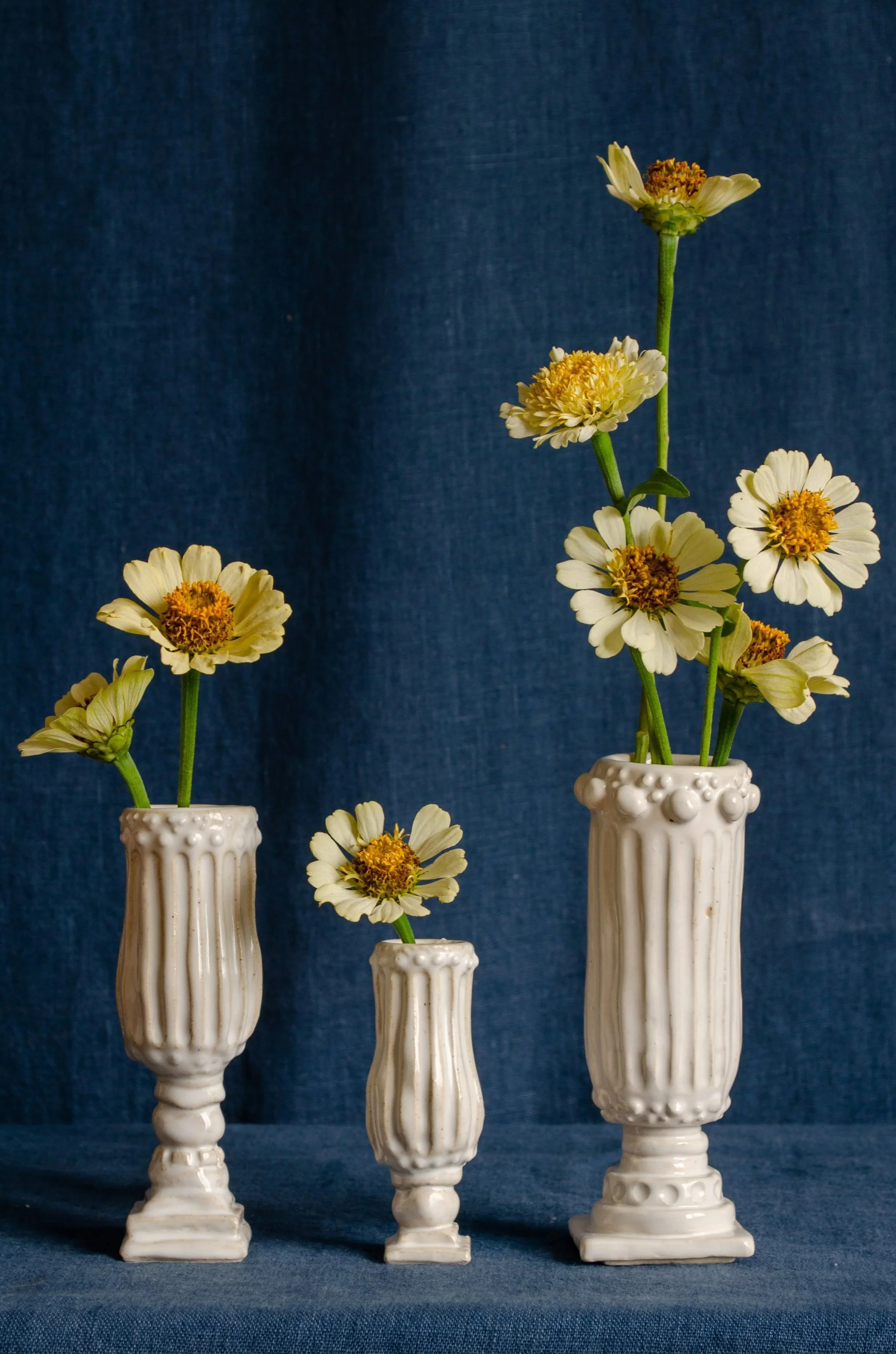 Three small vases with flowers