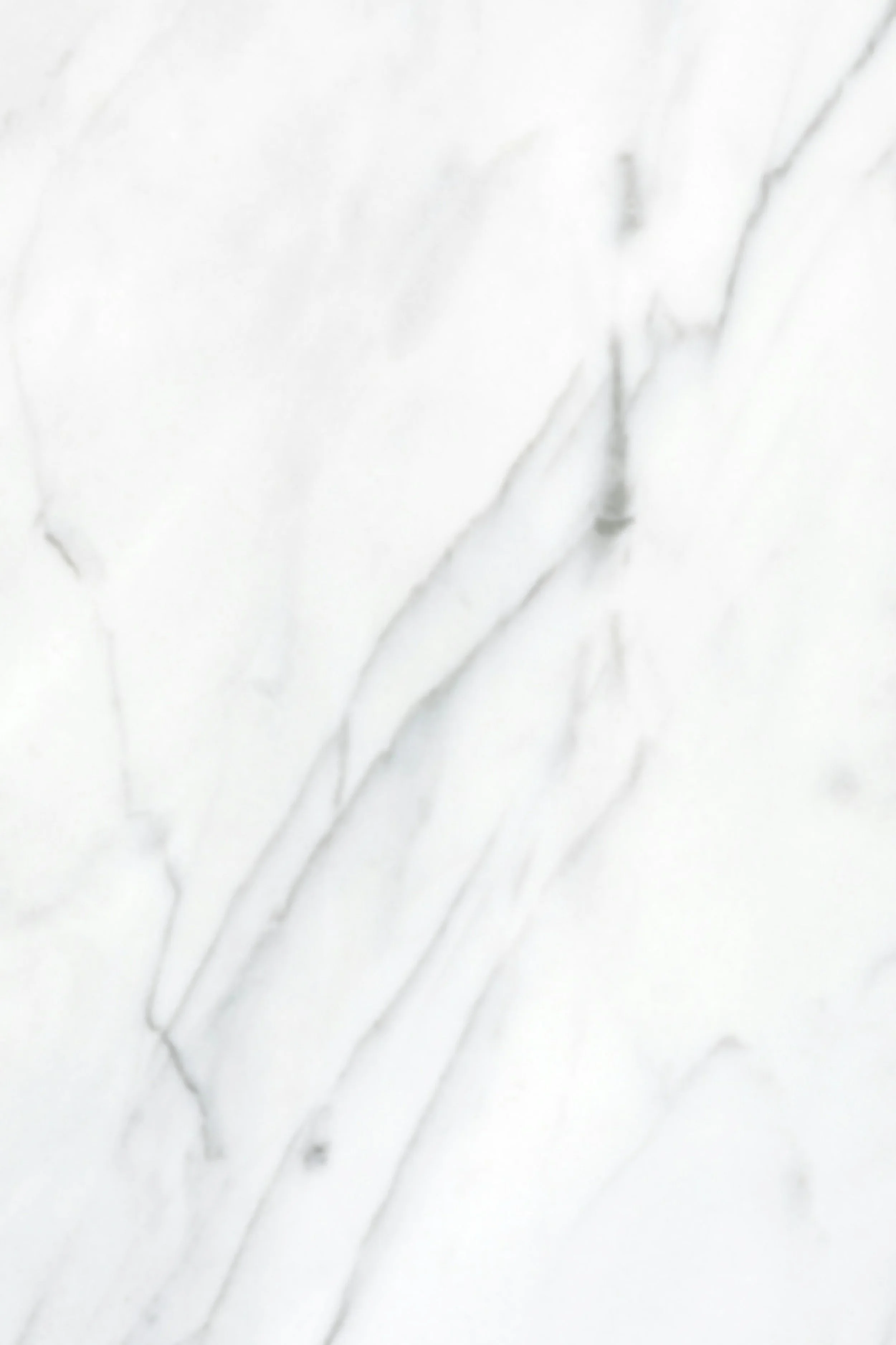 Close-up of white marble surface with gray veining.