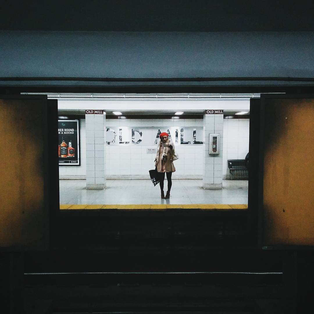 Person standing at subway station platform