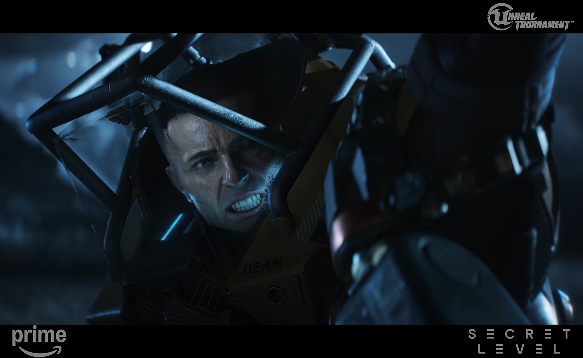 A man with a distressed expression, inside a protective helmet, confronts another person in a dark, intense scene from a science fiction movie.
