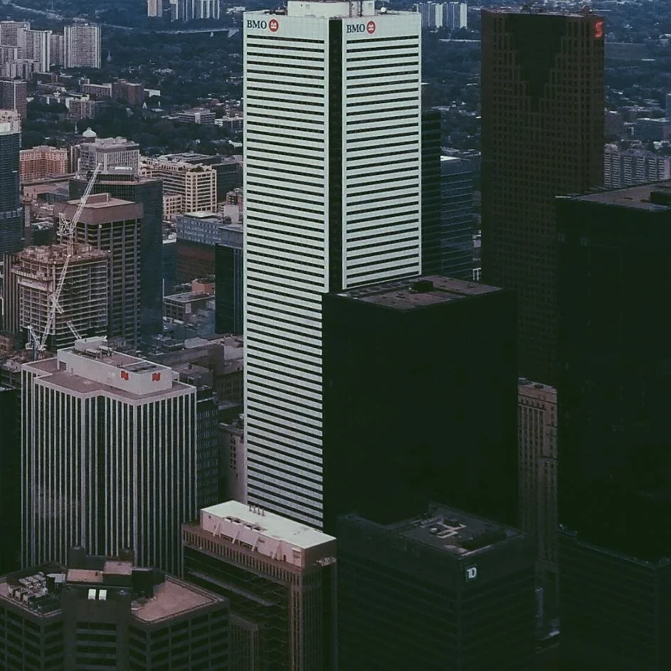 Aerial view of tall buildings in a city, including a prominent white skyscraper with the BMO logo at the top.