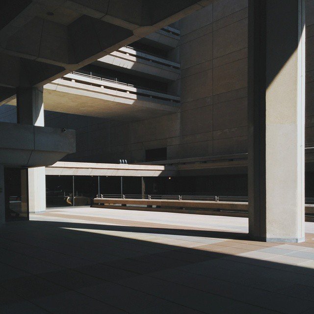 Empty concrete structure with multilevel balconies and harsh shadows