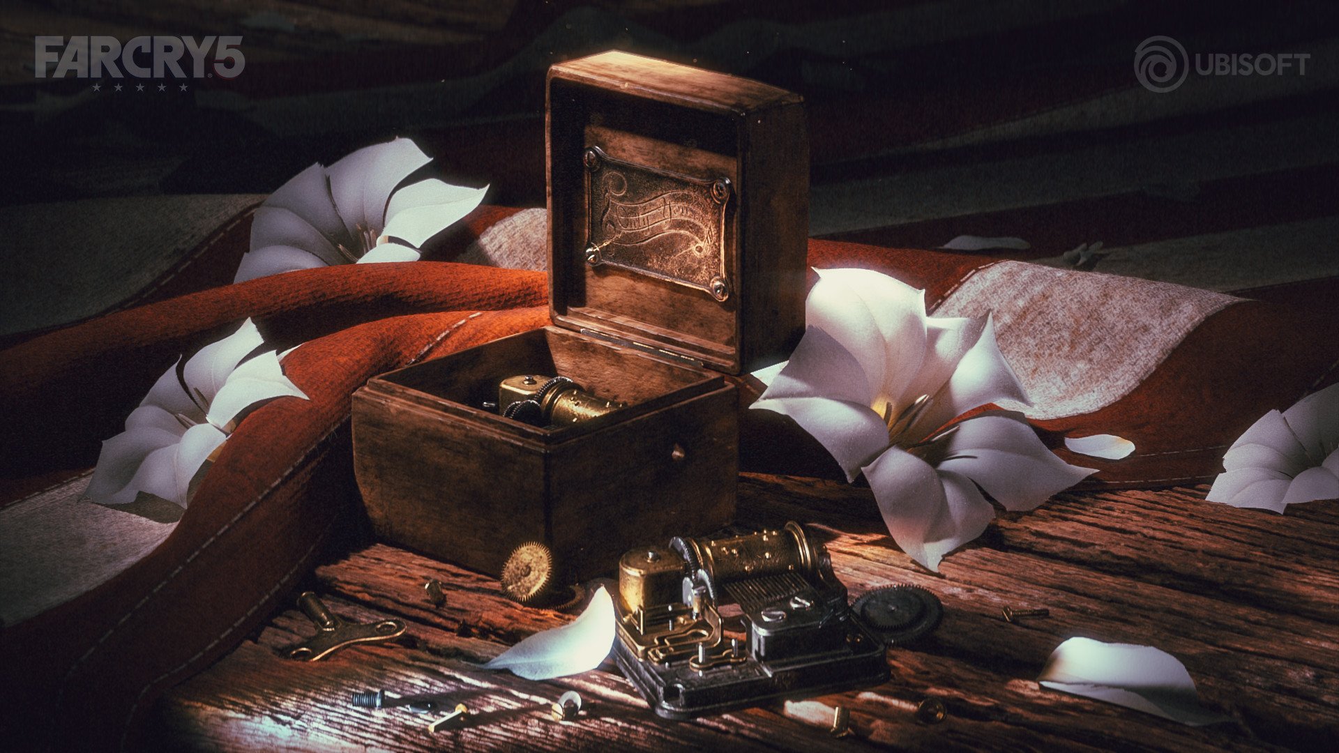 A vintage typewriter inside a wooden box with an open lid, placed on a rustic wooden surface. Surrounding it are white lilies, a red cloth, and scattered metal objects and gears. The scene has soft lighting and a dark background, with the logos 'FAR CRY 5' and 'UBISOFT' in the top corners.