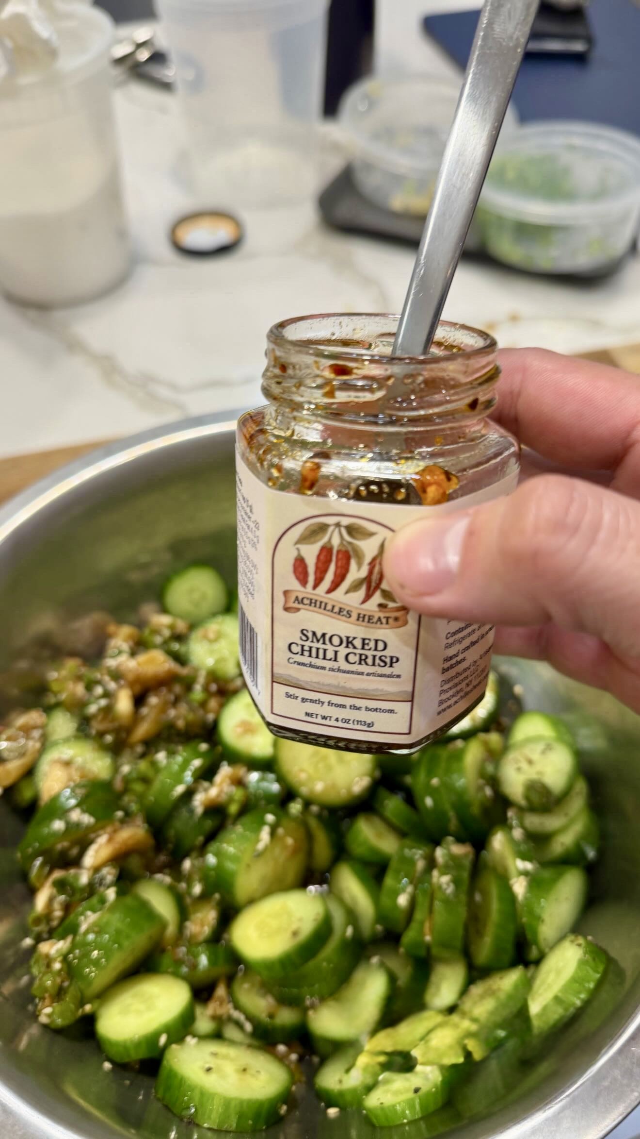Cold cucumber salad finished with Achilles Heat smoked chili crisp by Chef Johnny Phuoc Huynh.