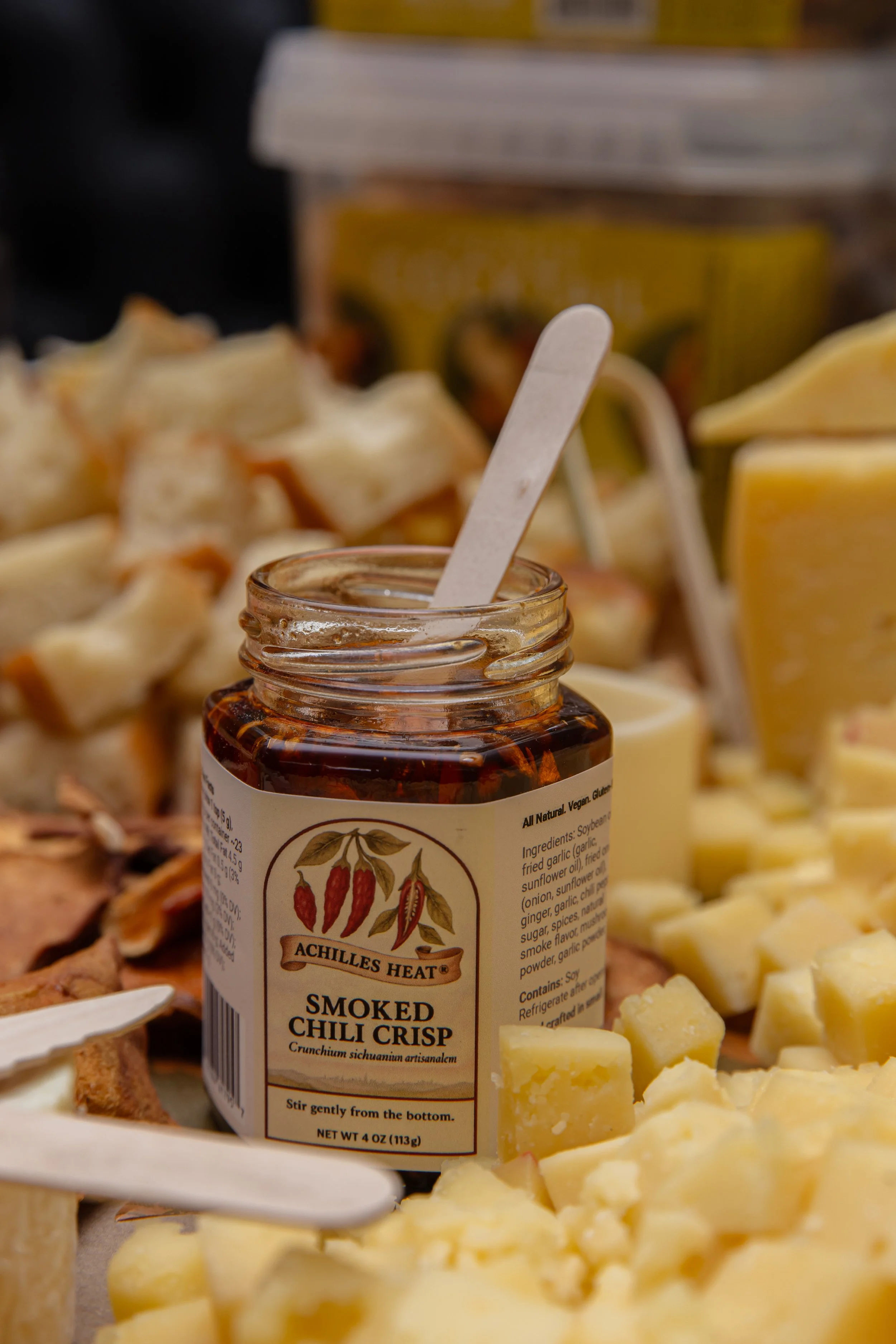 Achilles Heat Smoked Chili Crisp makes a  perfect pairing with @jasperhillfarm Alpha Tolman. This incredible cheese and charcuterie table was part of The Metro Cheese Club x Curious Elixirs: The Great Curious Cocktail Party, Williamsburg, Brooklyn.