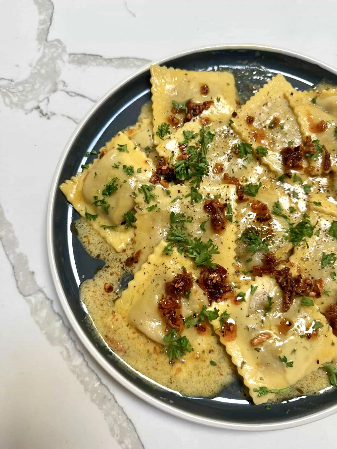 Brown butter ravioli finished with Achilles Heat Smoked Chili Crisp by Chef Johnny Phuoc Huynh