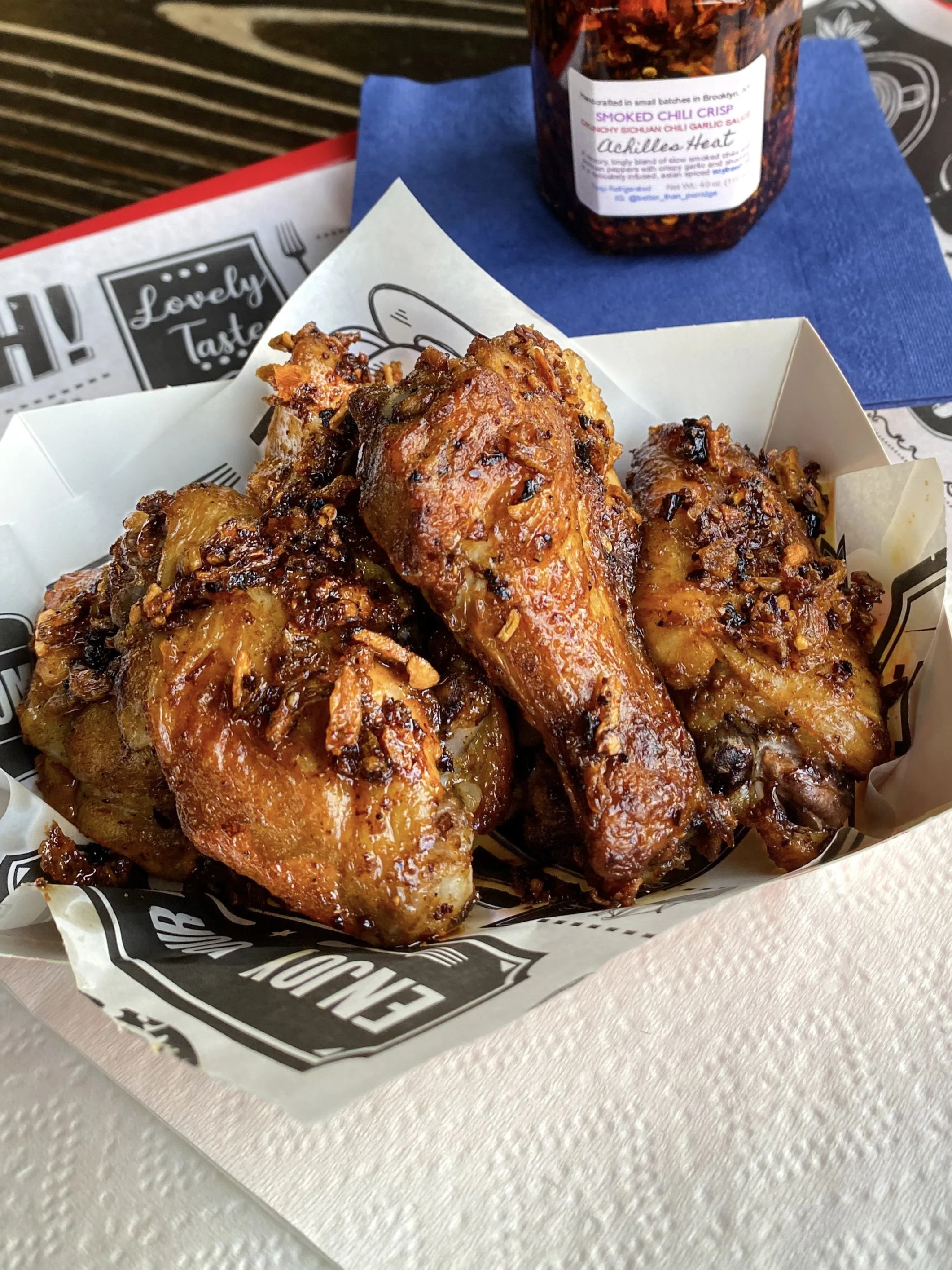 Smoked chicken wings tossed in Achilles Heat smoked chili crisp