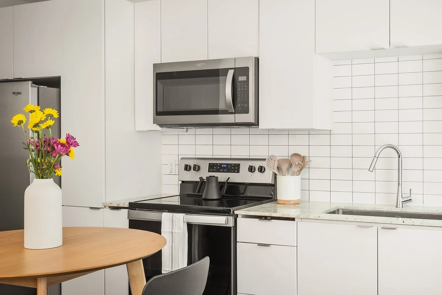 This project takes cues from European and Scandinavian design&mdash;an all-white, functional interior that keeps costs focused where it matters most. Simplicity forms the foundation, while small accents of contrast in the furnishings bring warmth, ch