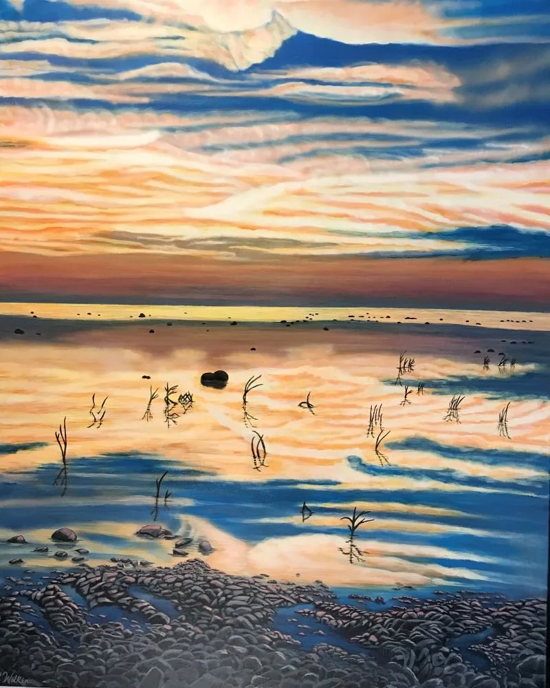 A serene landscape painting of a sunset over a calm body of water, with colorful clouds in the sky, rock formations known as "kettles" or "concretions" and sparse plants reflected on the still water's surface.
