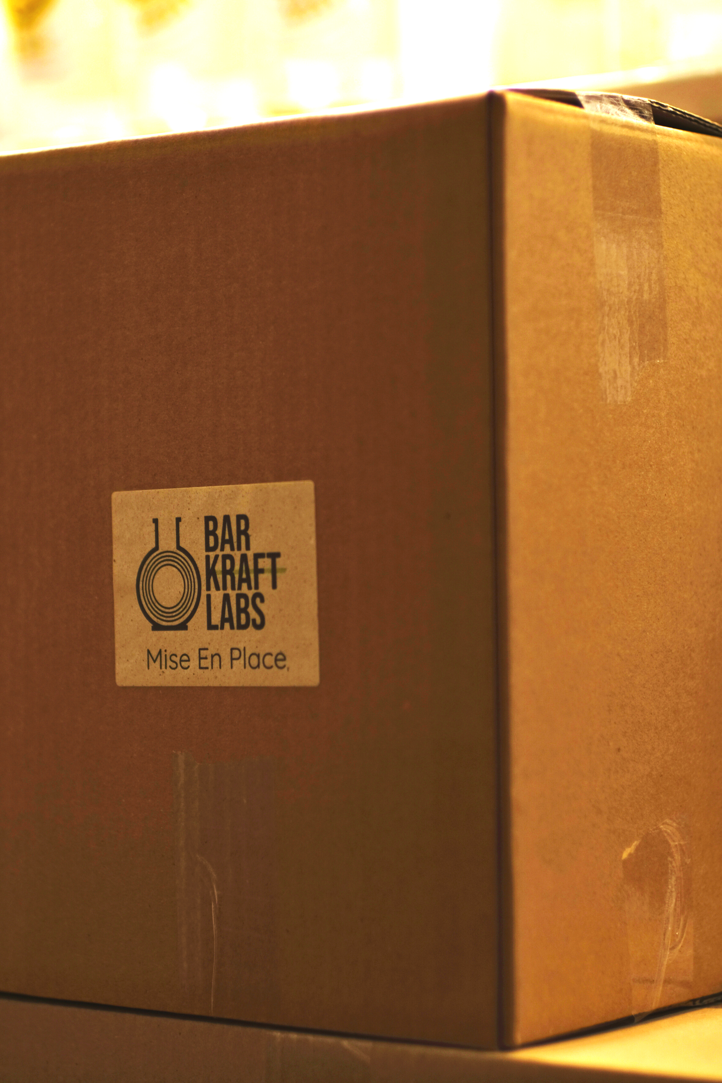 A cardboard box with a label that reads 'Bar Kraft Labs, Mise En Place.'