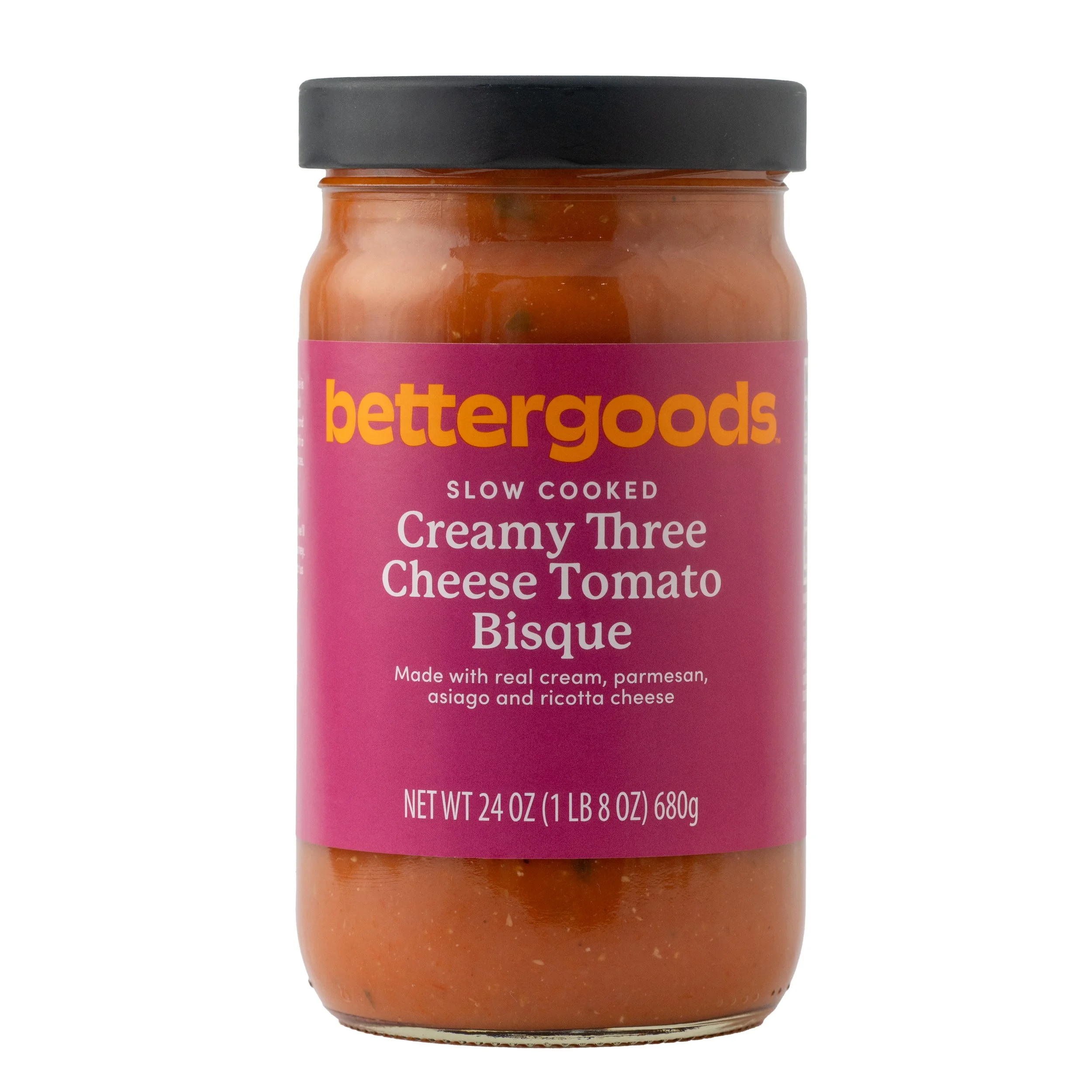 A jar of Better Goods Creamy Three Cheese Tomato Bisque with a purple label and black lid.