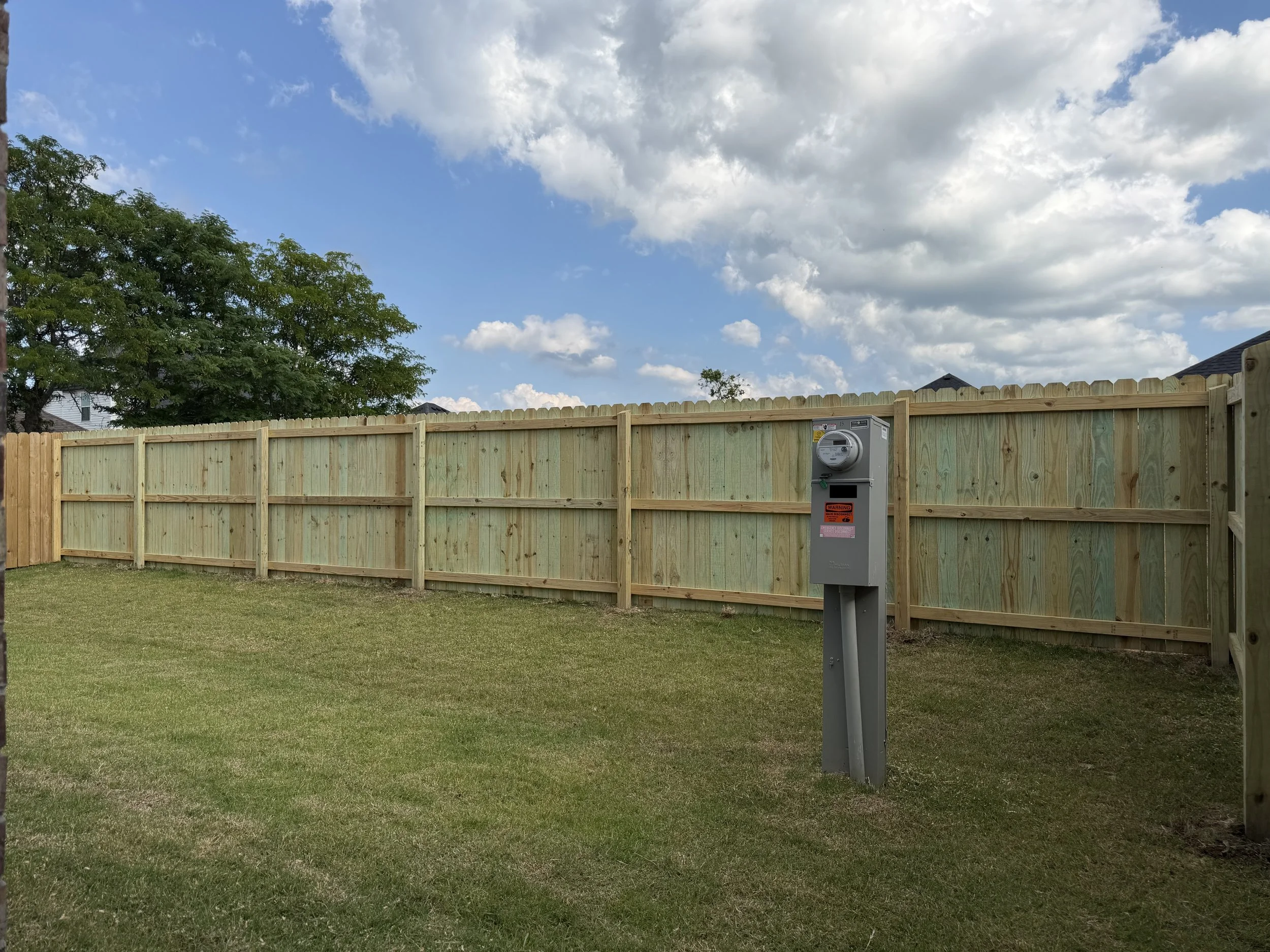 Completed pressure-treated pine privacy fence near Rupple Road in West Fayetteville.