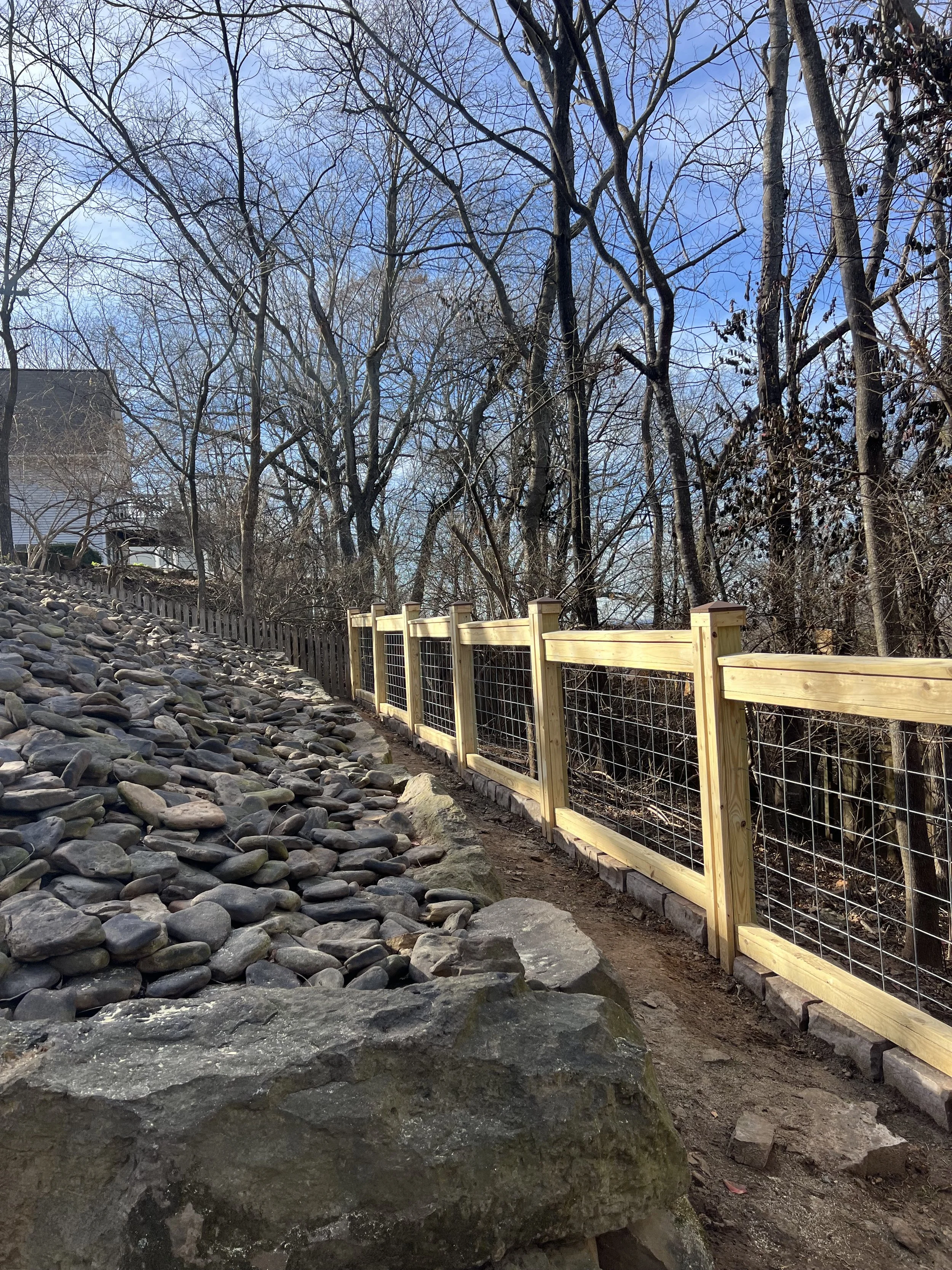 Custom pressure-treated pine fence with six-gauge cattle-panel infill in Fayetteville