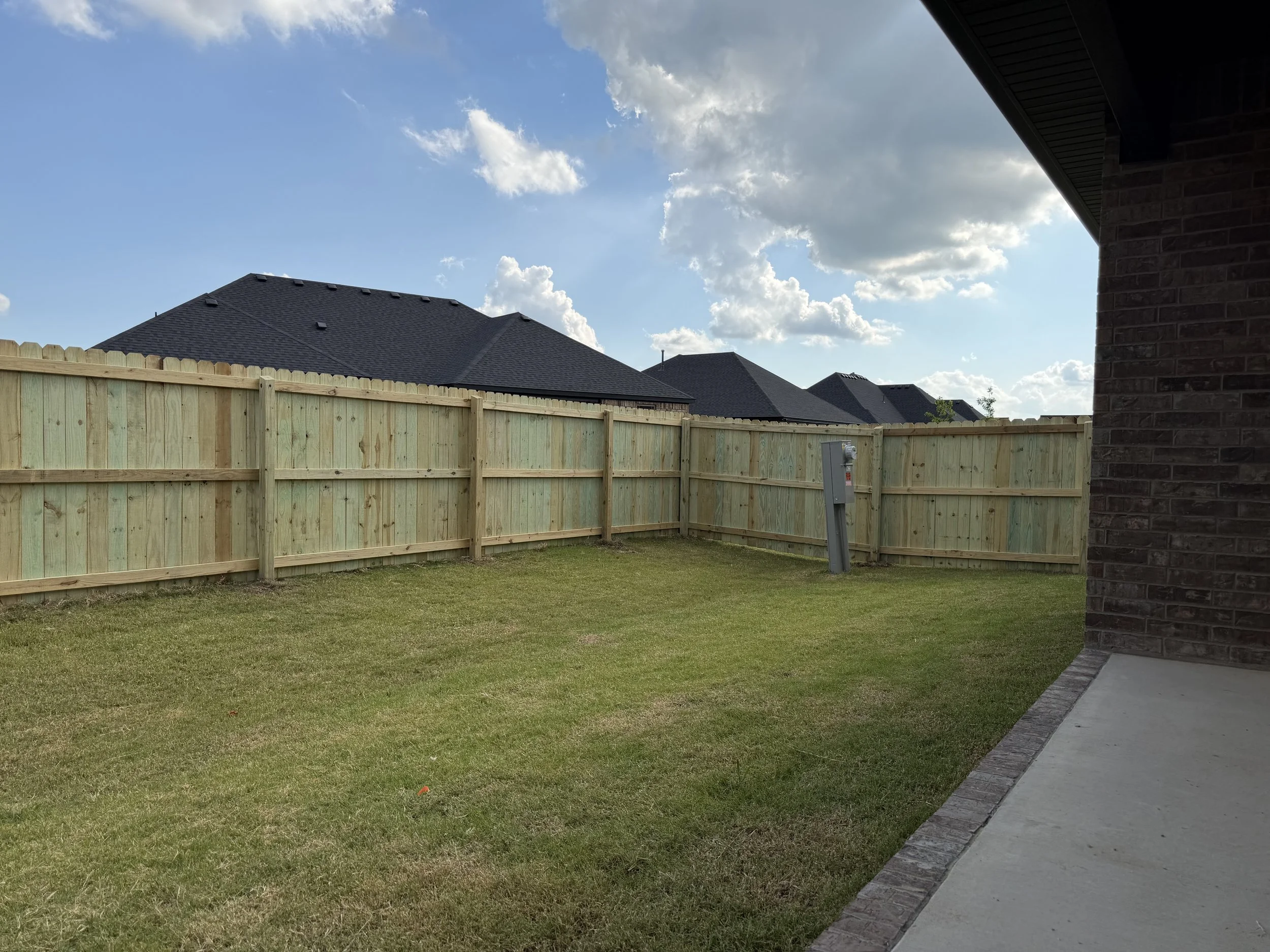 Six-foot pressure-treated pine privacy fence installed in West Fayetteville, Arkansas.