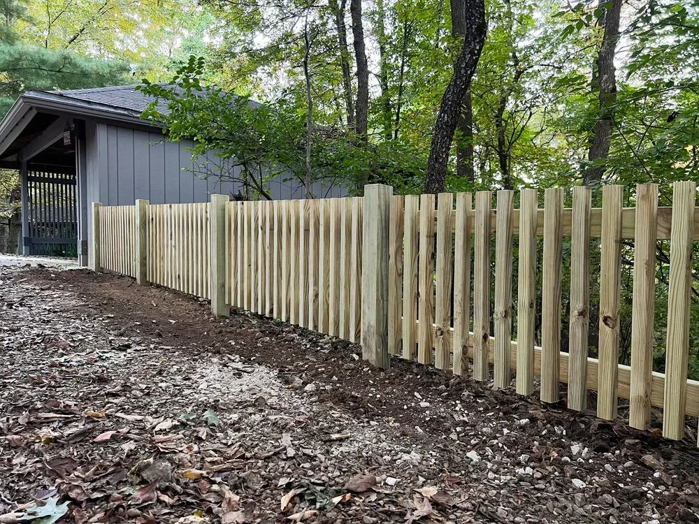 Custom low-profile pressure-treated pine boundary fence installed near Mount Sequoyah in Fayetteville, Arkansas.