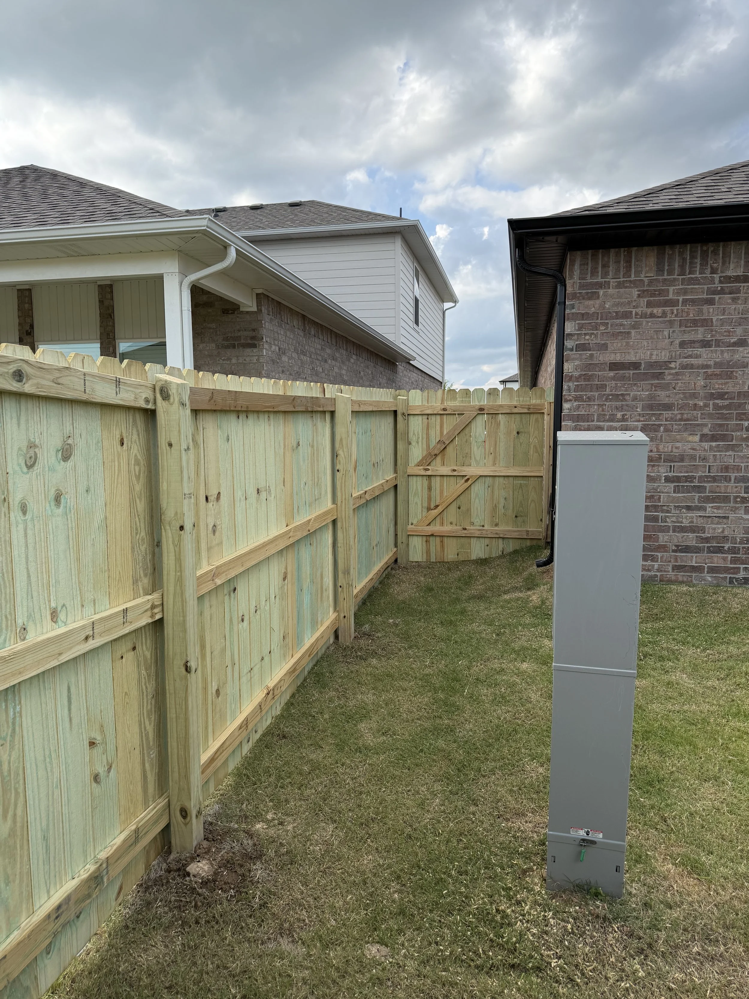 Completed pressure-treated pine privacy fence near Rupple Road in West Fayetteville.