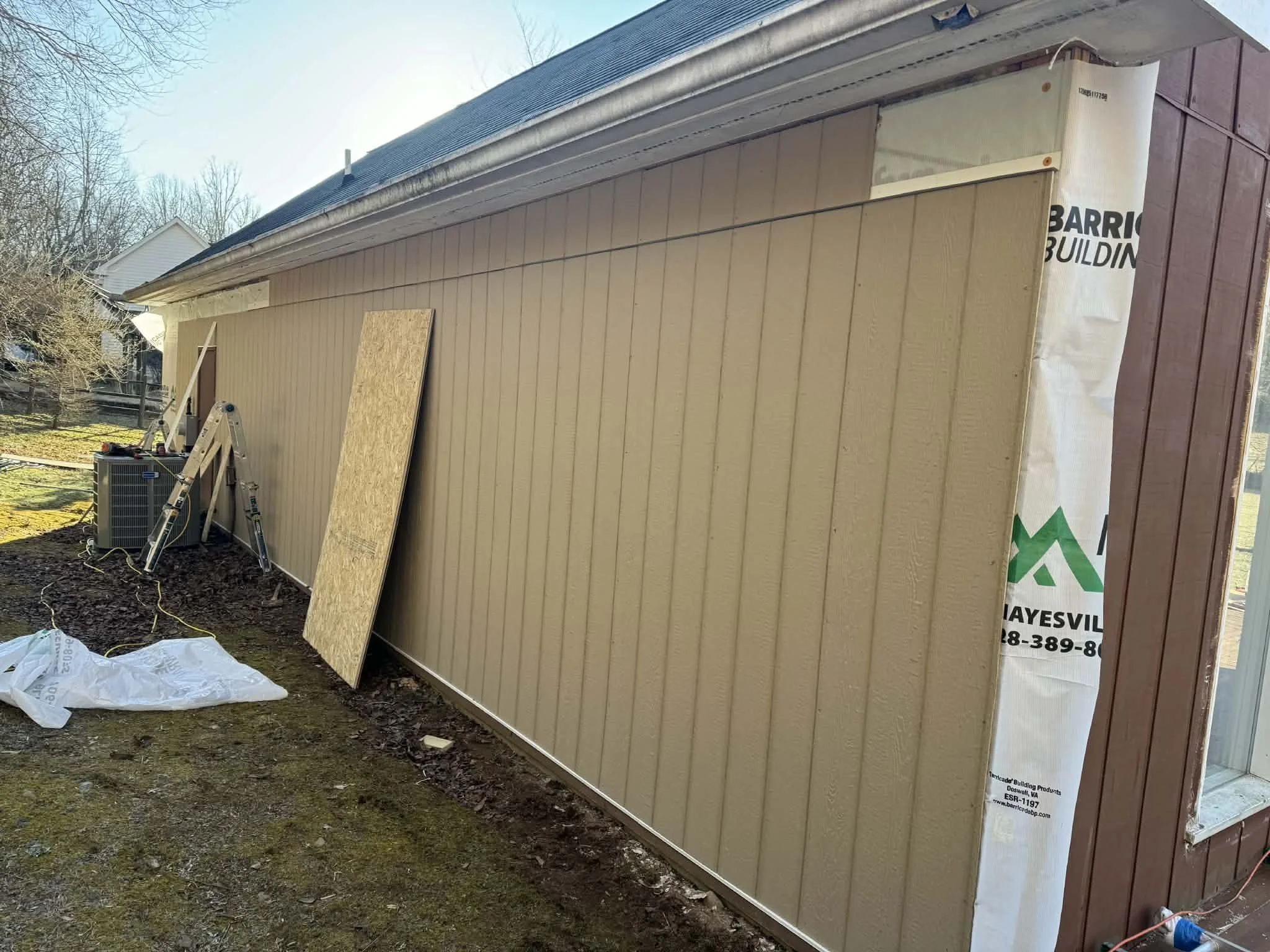 Demo and prep work included removing existing siding and trim, removing a door, framing a new window, installing new house wrap & T1-11, and flashing all doors and windows.