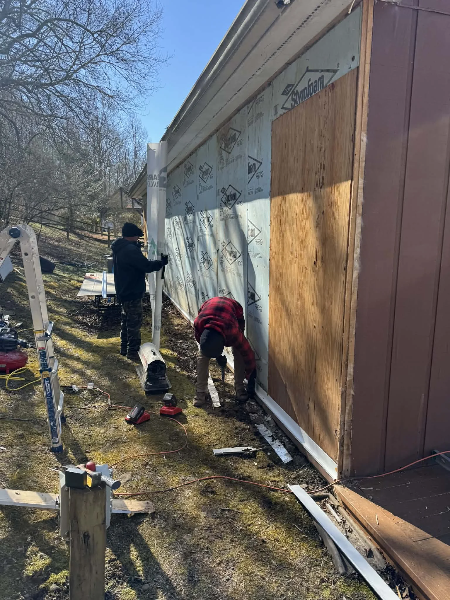 Demo and prep work included removing existing siding and trim, removing a door, framing a new window, installing new house wrap & T1-11, and flashing all doors and windows.
