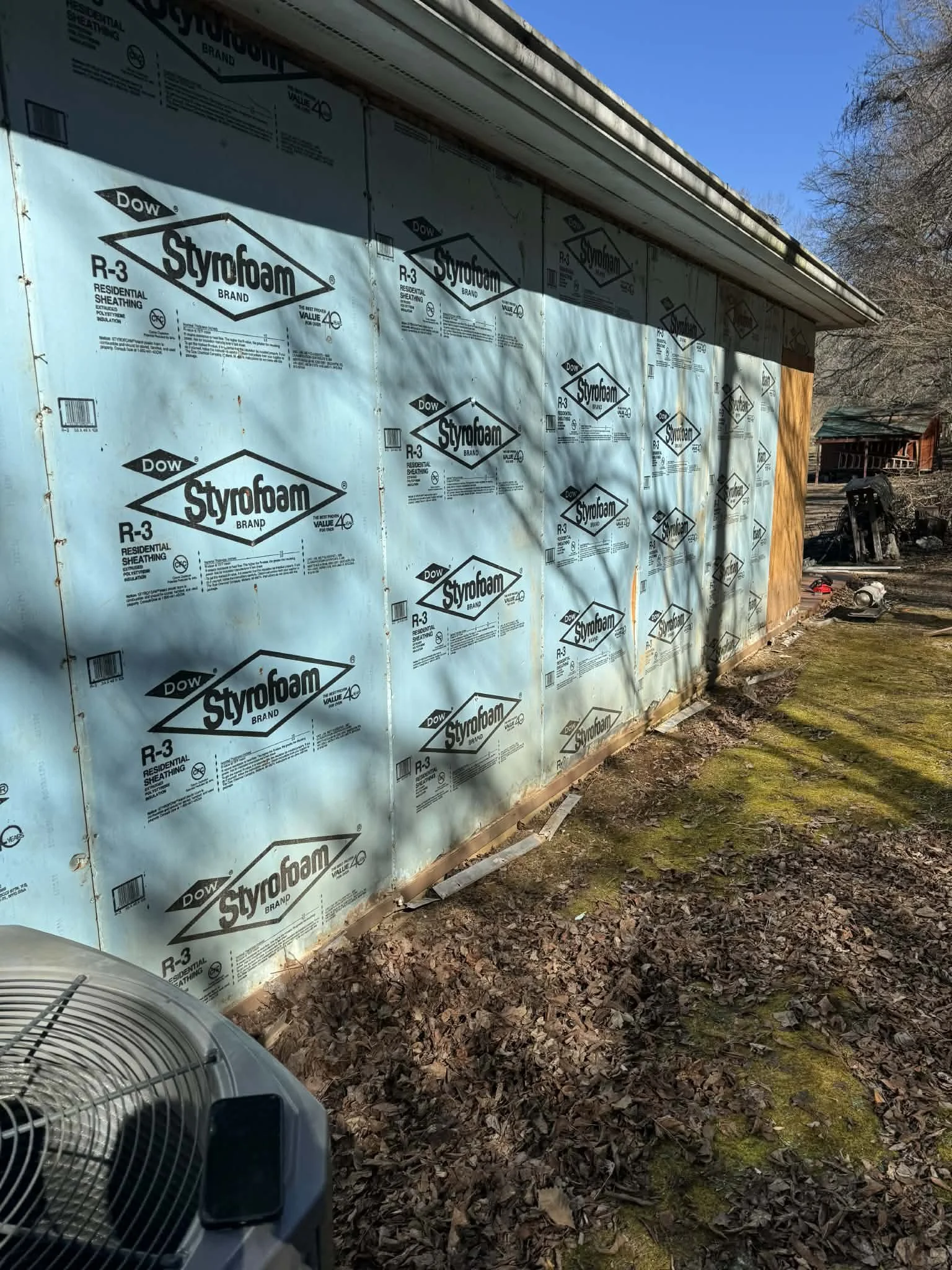 Demo and prep work included removing existing siding and trim, removing a door, framing a new window, installing new house wrap & T1-11, and flashing all doors and windows.