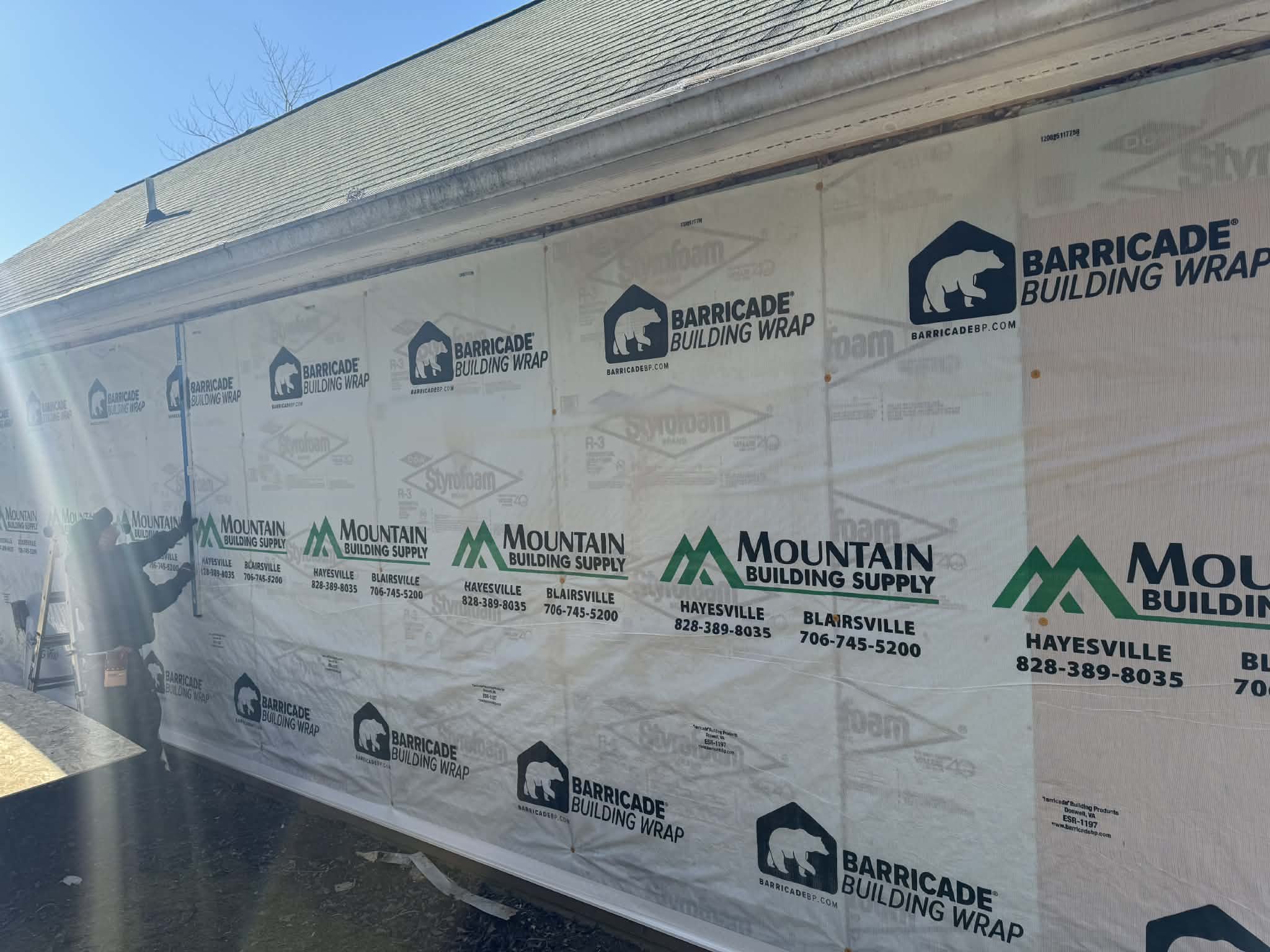 Demo and prep work included removing existing siding and trim, removing a door, framing a new window, installing new house wrap & T1-11, and flashing all doors and windows.