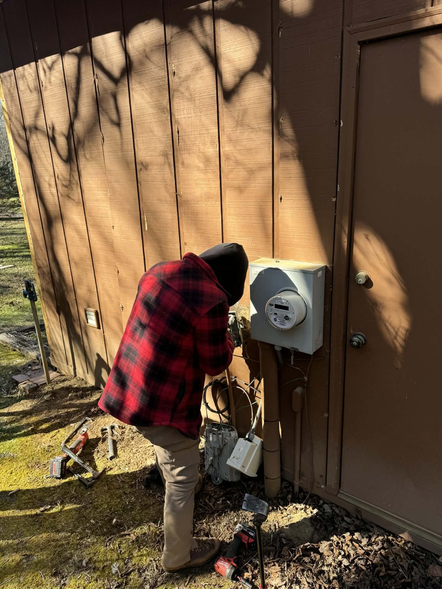 Demo and prep work included removing existing siding and trim, removing a door, framing a new window, installing new house wrap & T1-11, and flashing all doors and windows.