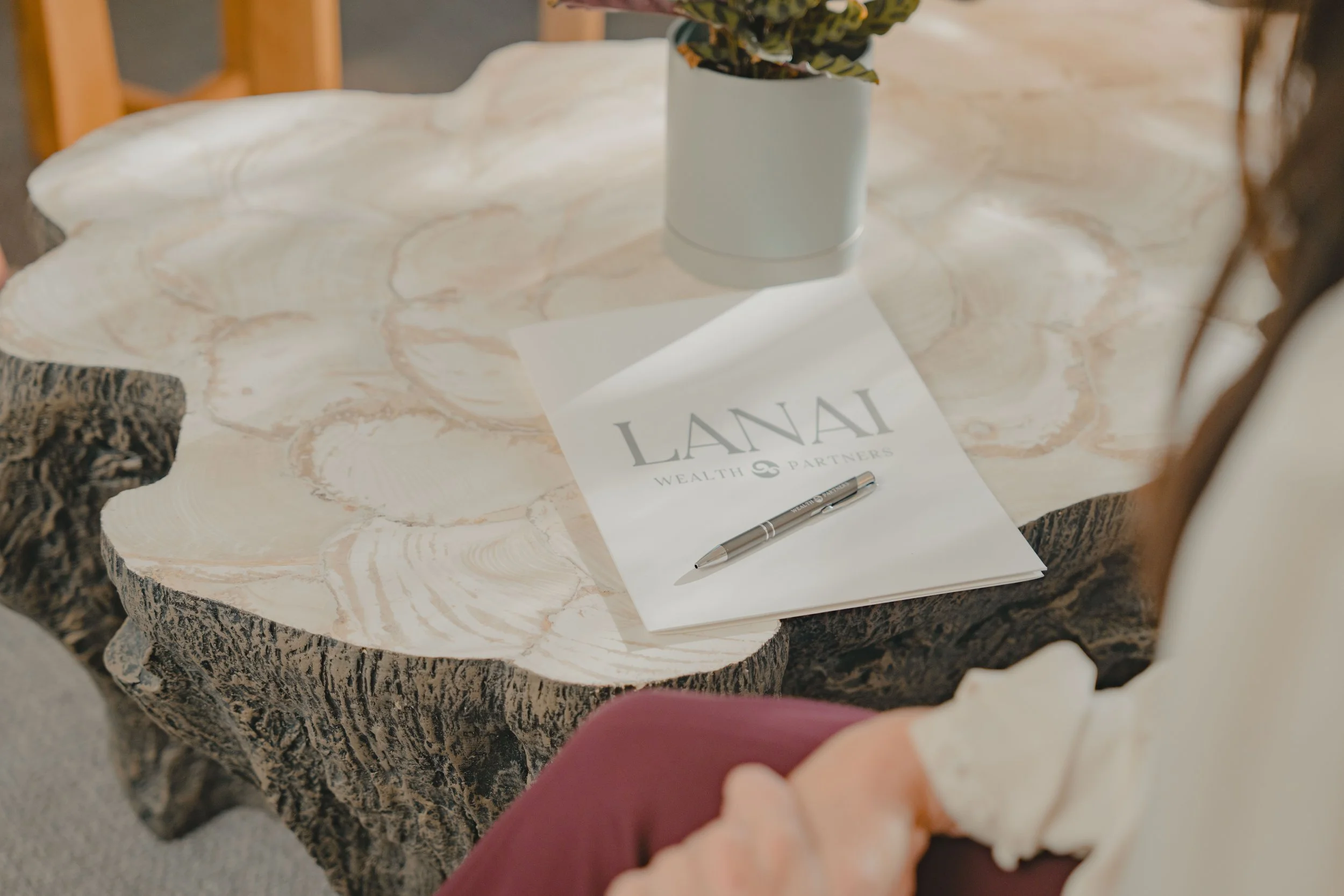 Lanai Wealth Partners folder sitting on a table in the office.