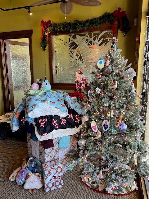 A photo of a christmas tree and presents for Jacob's Heart