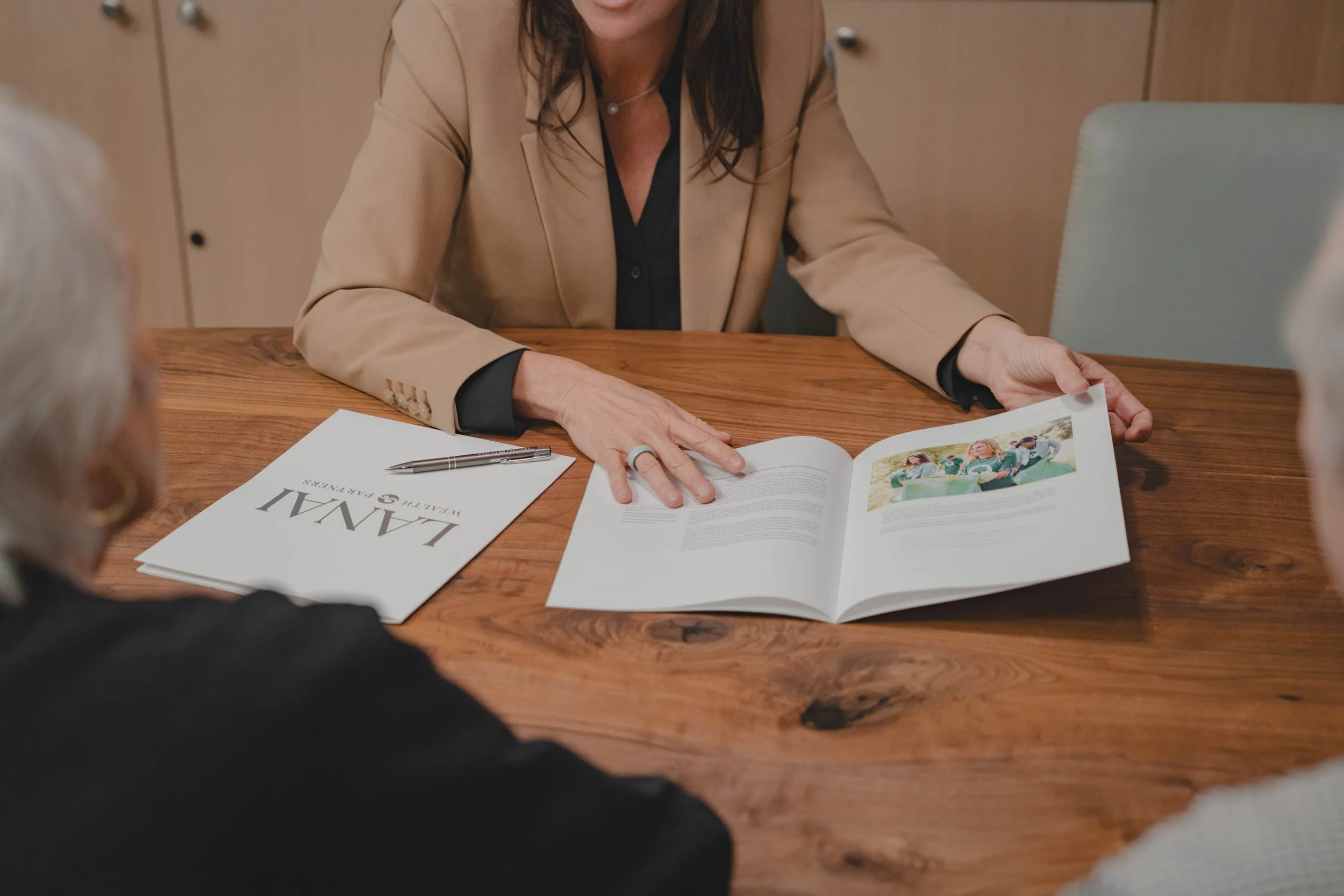 A photo of Christine showing financial options to a client.