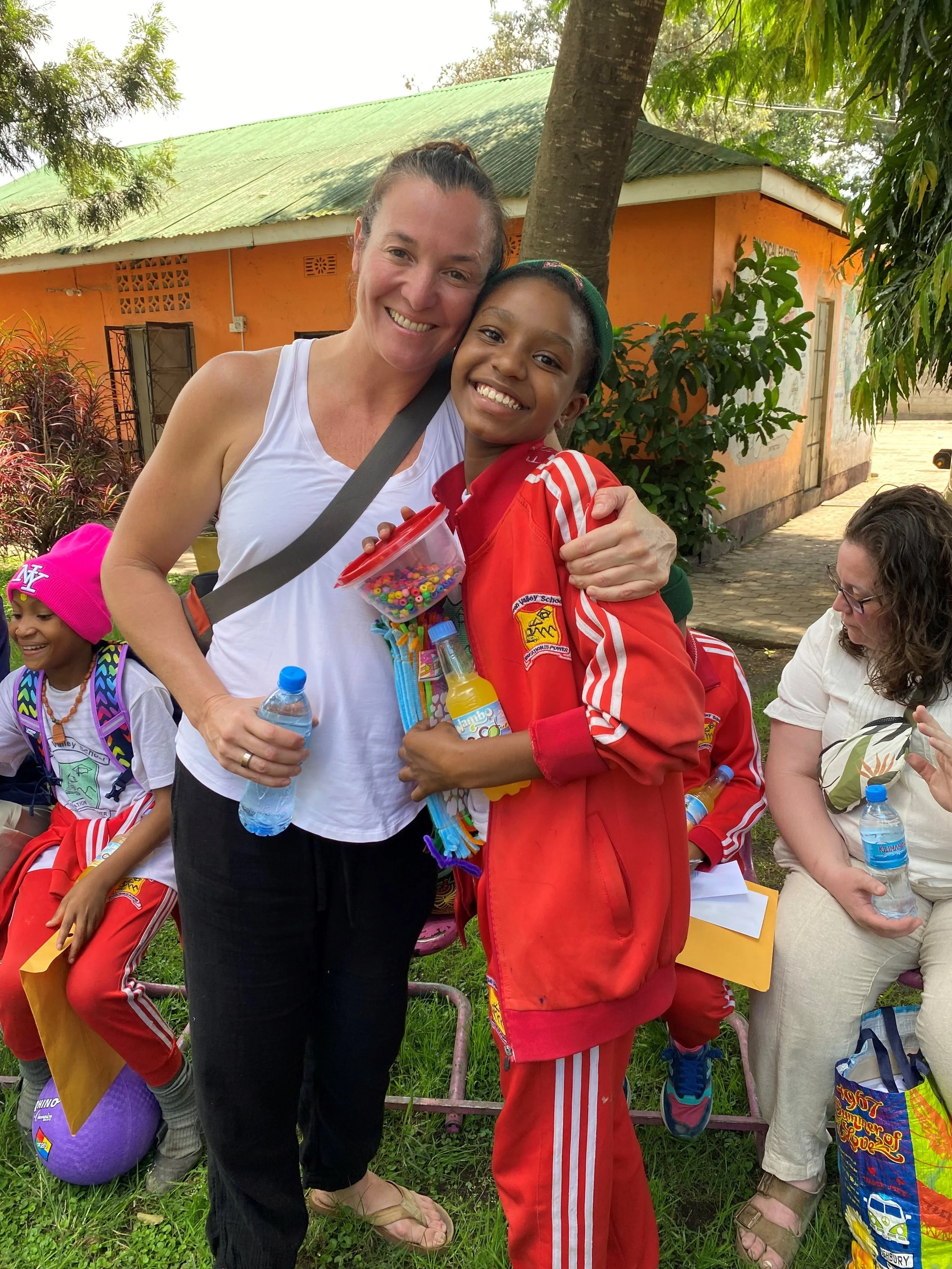 Christine with a young girl supporting Educating Tanzania Foundation