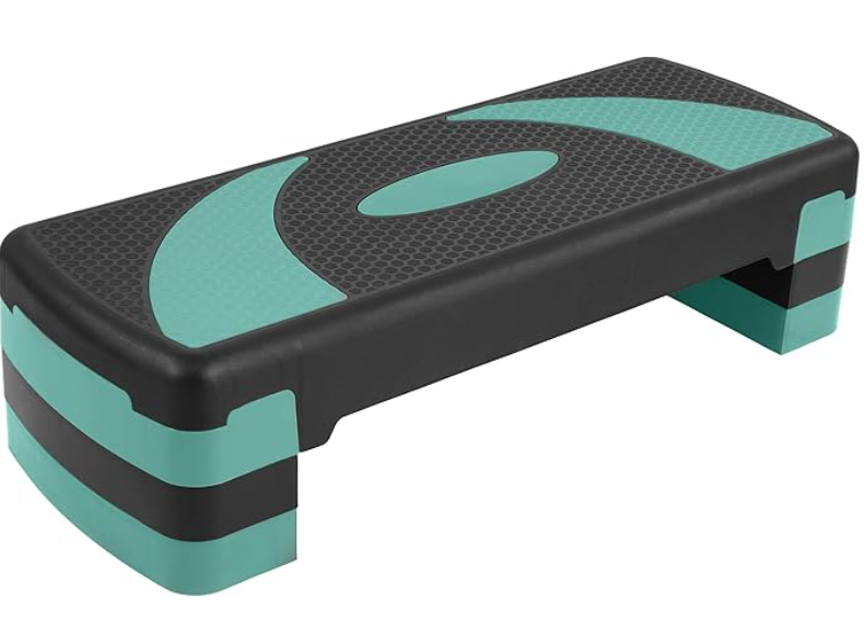 Aerobic step platform with black and teal colors, rectangular shape, textured surface, and short legs.