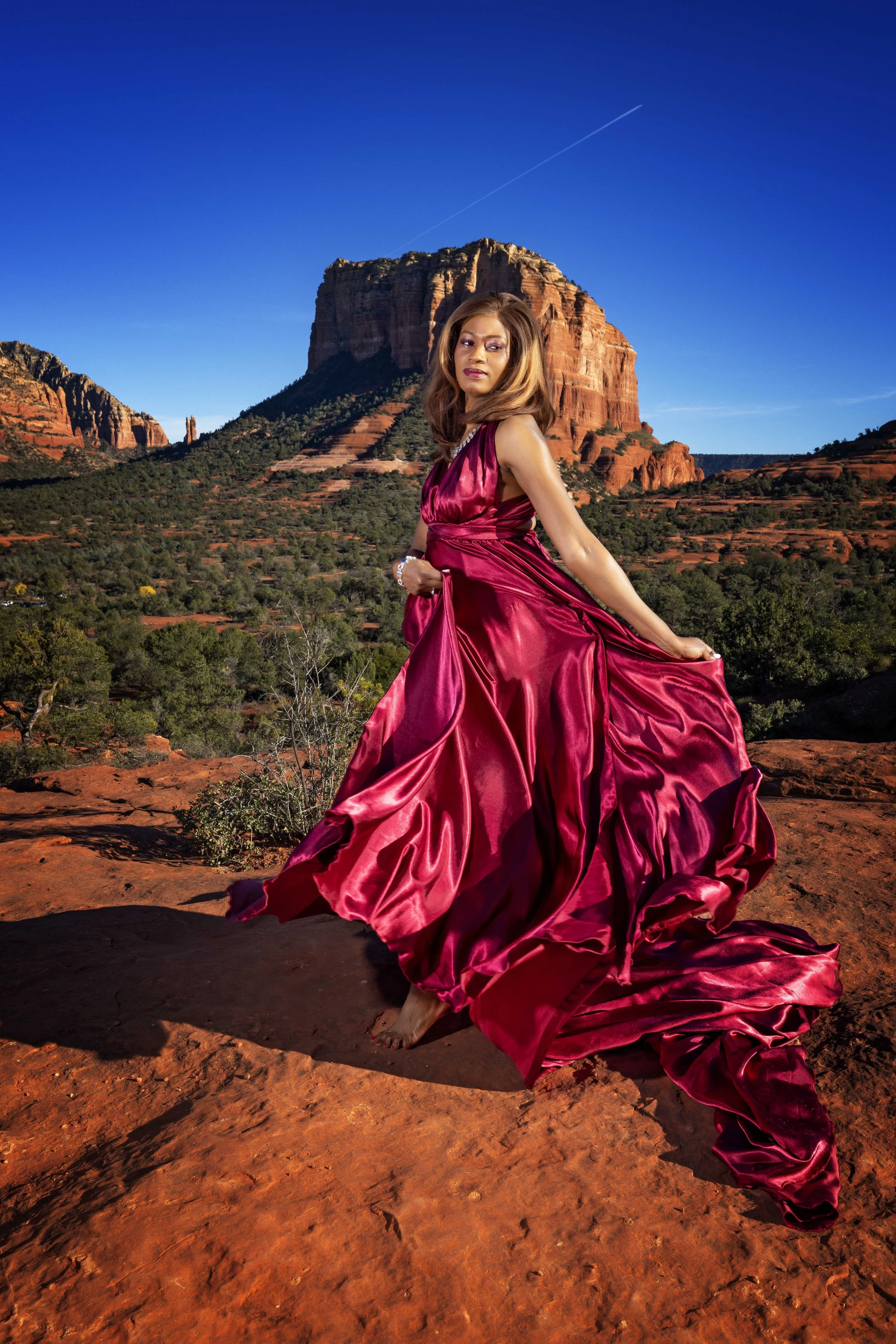 portrait of a lady dancing in  a flying dress in Sedona,az 
