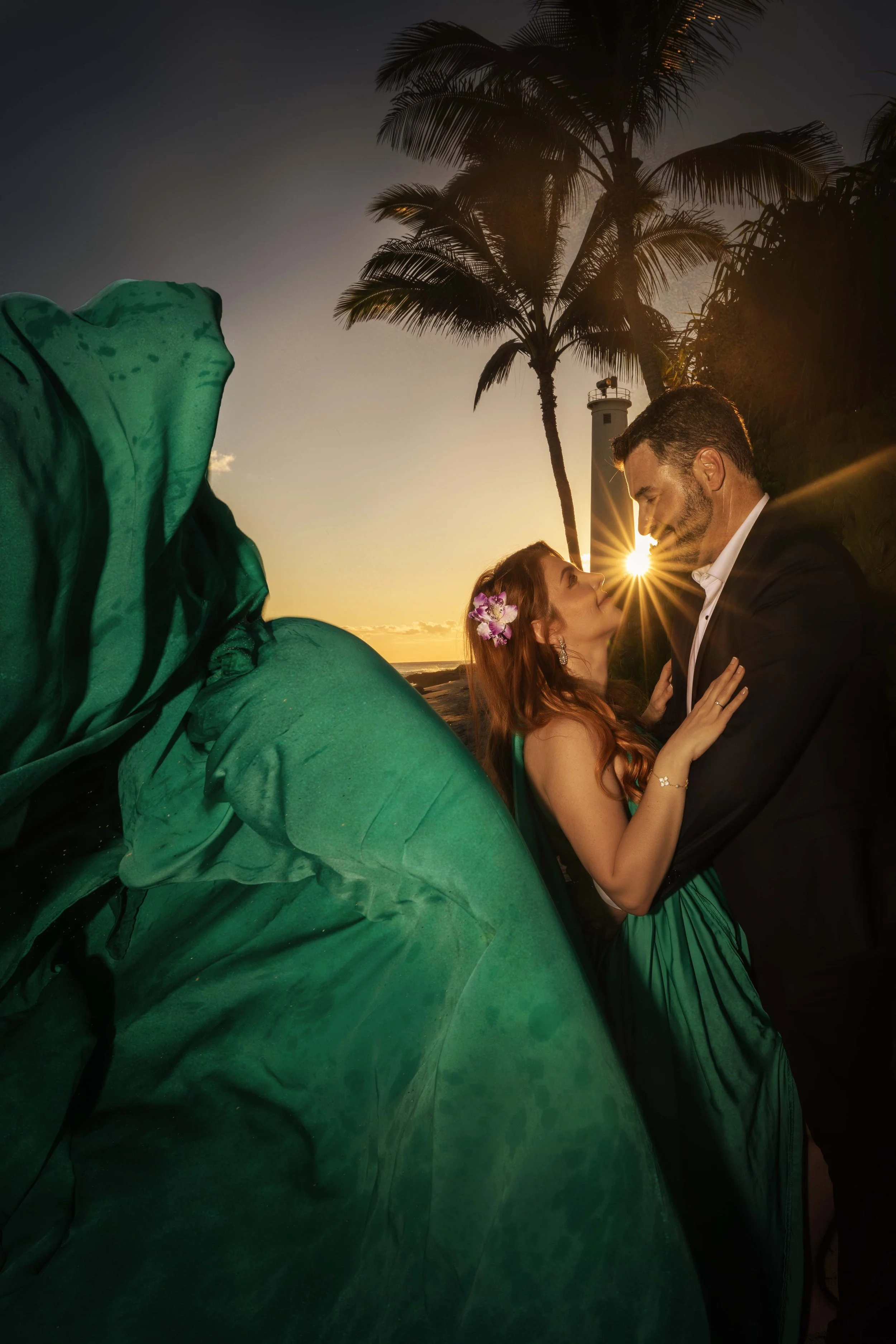 couple portrait in the flying dress at sunset with palm tresss