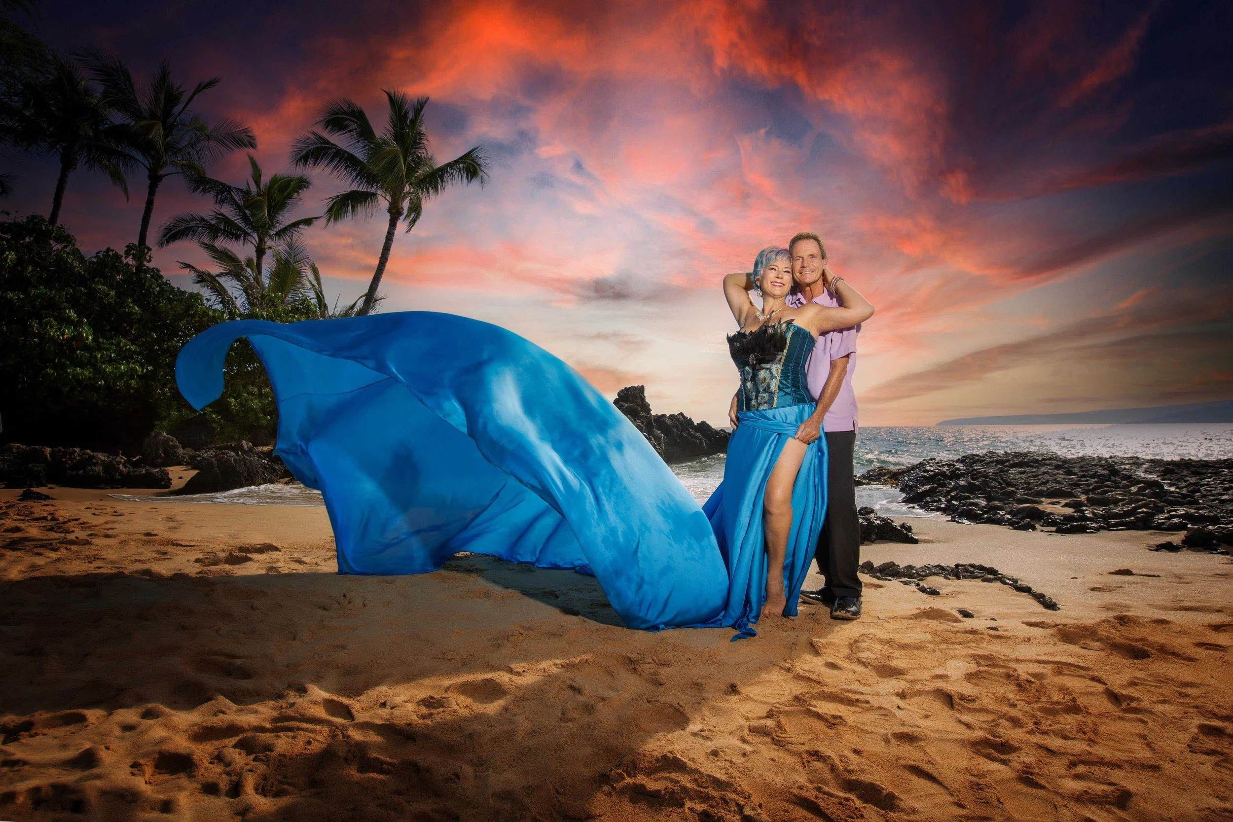 couple portrait at the beach lady wearing a blue flying dress