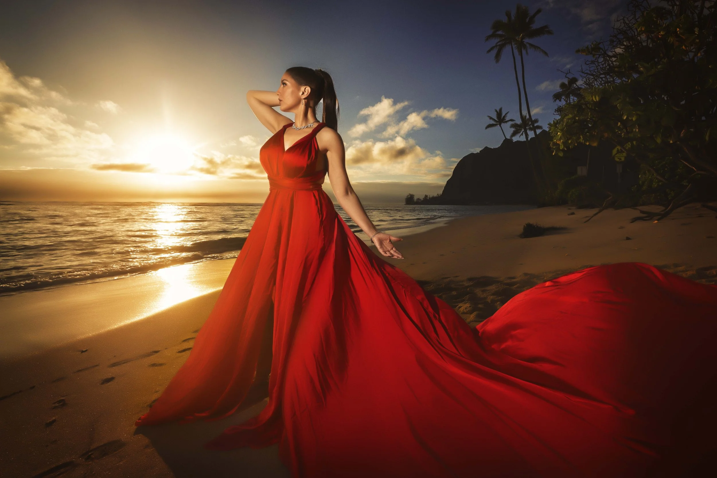 lady in a red flying dress at the beach