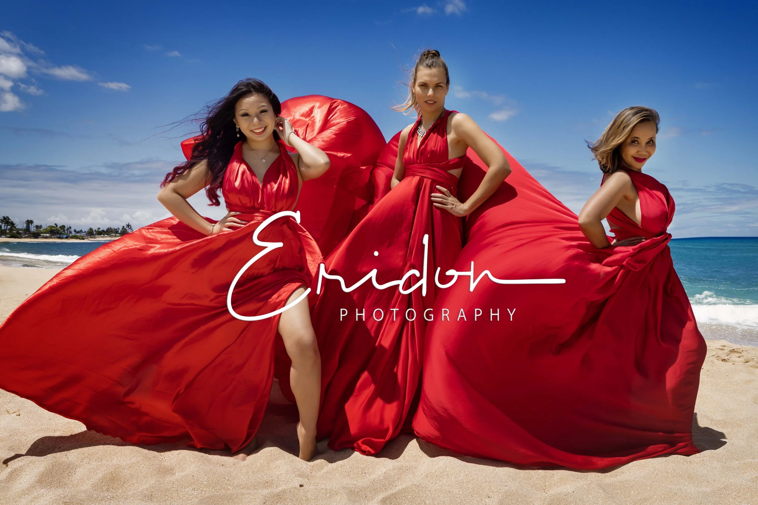 three ladies in flying dresses on the beach 