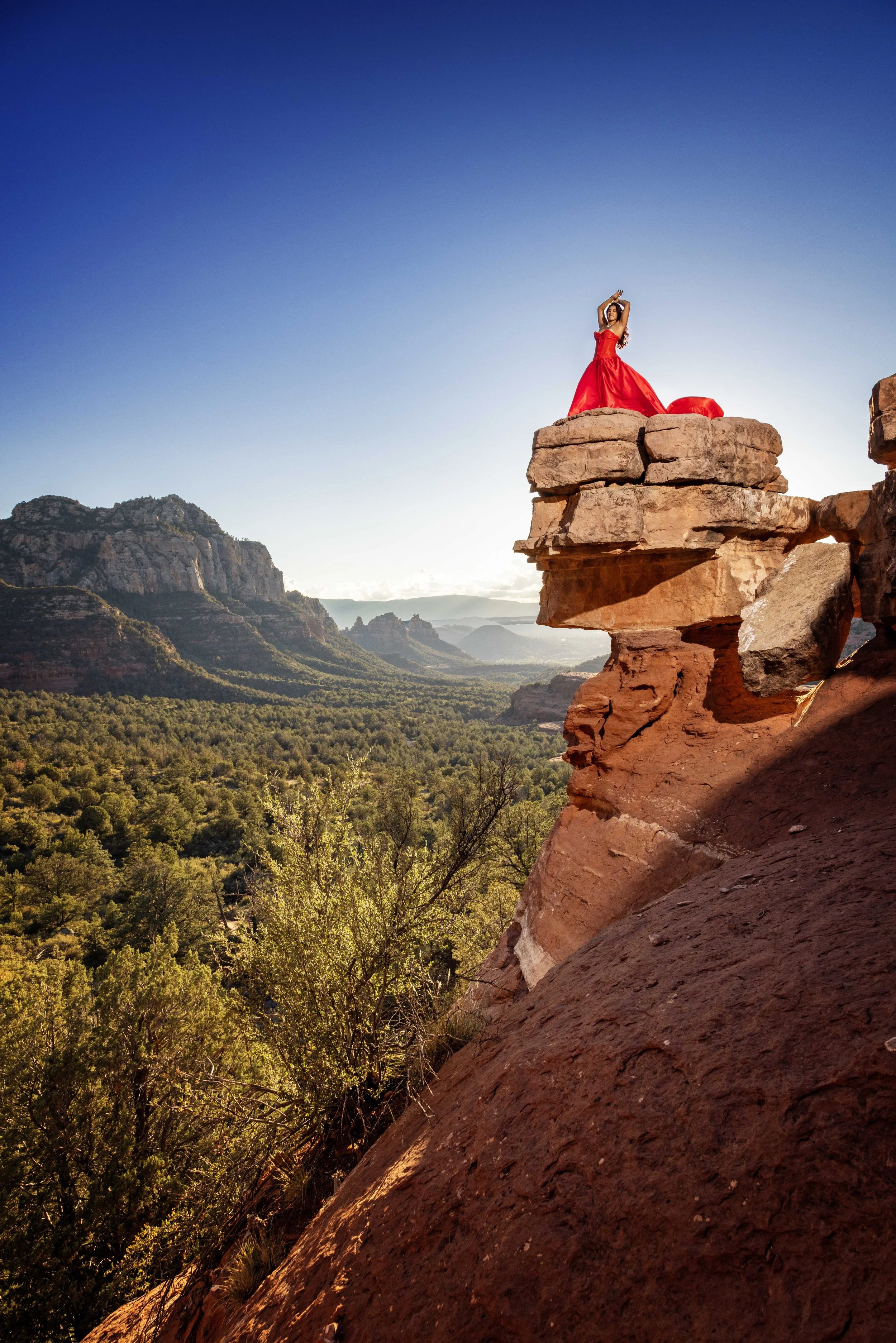 portrait of a lady in a red flying dress in Sedona. 