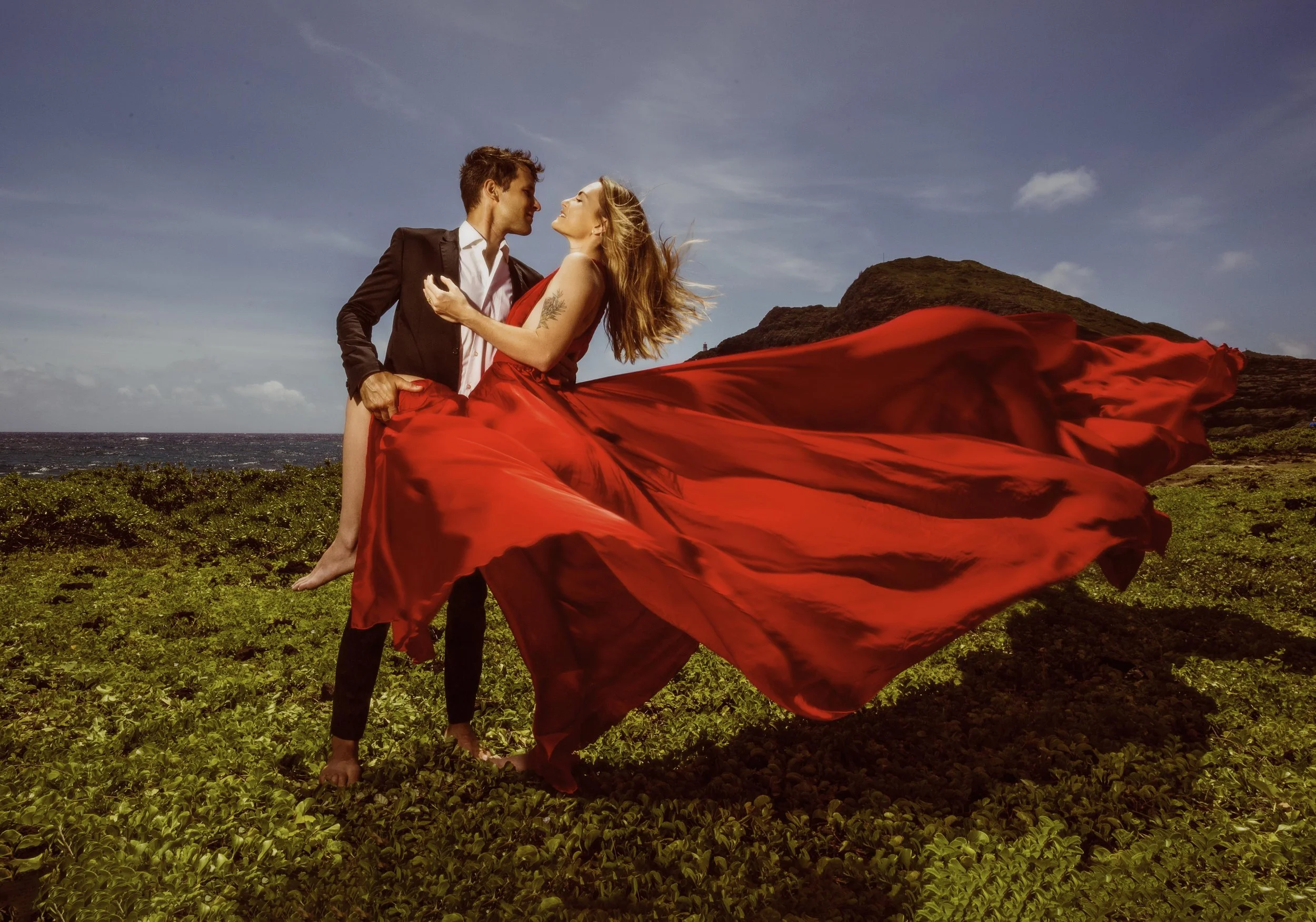 flying dress portrait with a couple wearing a red dress looks like a love novel cover