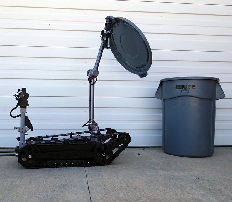 The MMP-40X-EOD robot inspecting the inside of a trash can for explosives.