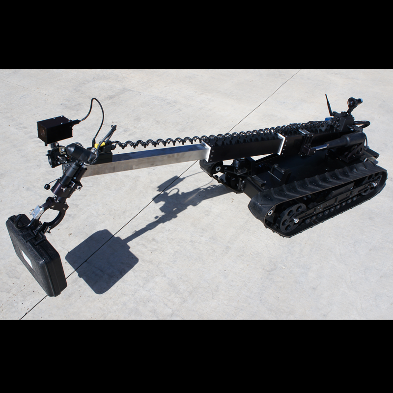 A law enforcement robotic machine with tank treads, a long arm with a camera and a sensor, and a control box at the end, situated on a concrete surface.
