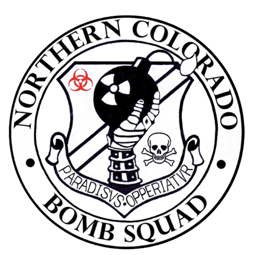 Emblem for Northern Colorado Bomb Squad featuring a cartoon bomb with a lit fuse, a biohazard symbol, a skull and crossbones, and the words 'Paradise's Operativur' on a banner.