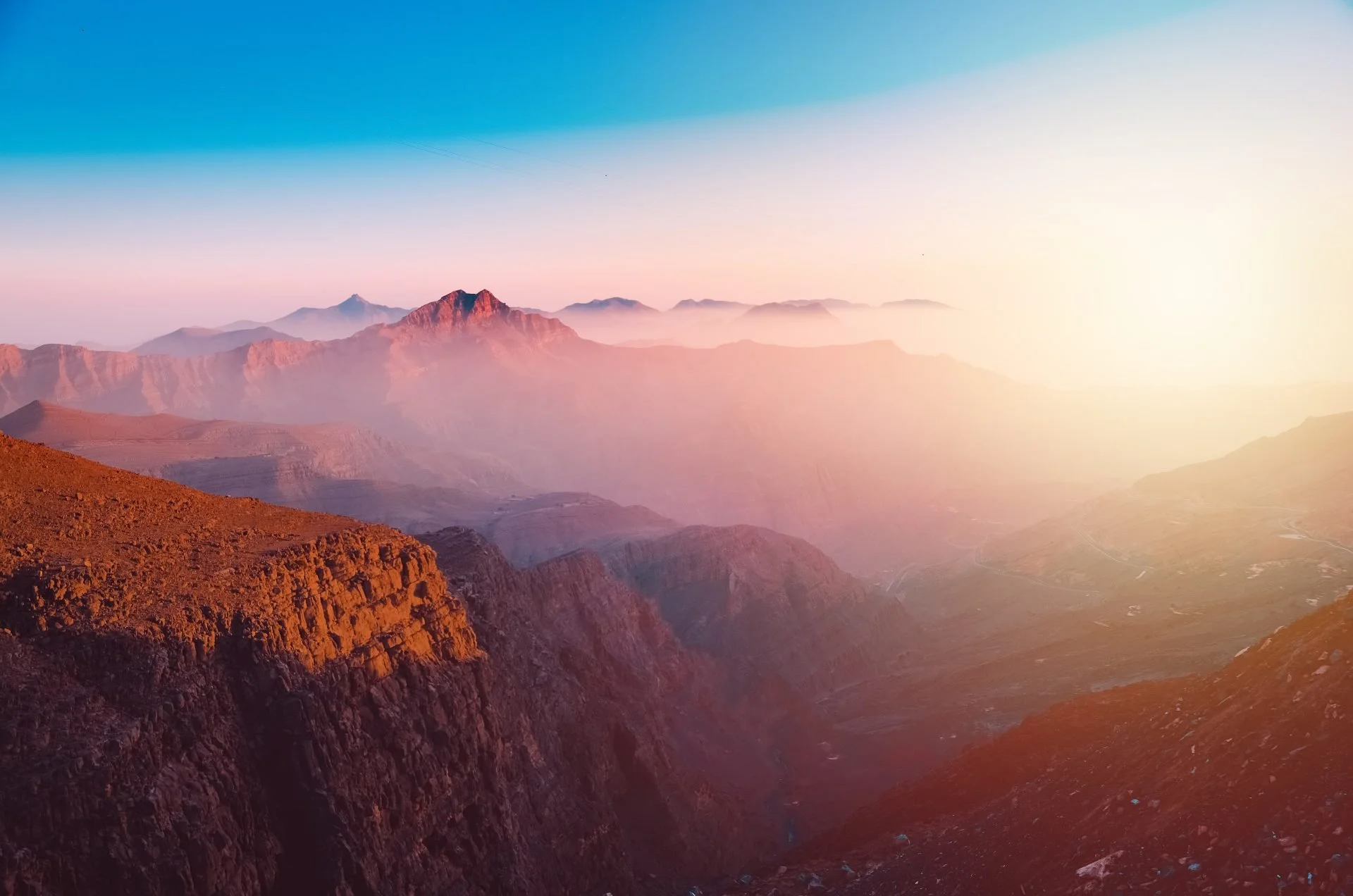 Mountain landscape at sunset with hazy peaks and colorful sky in Ras Al Khaimah