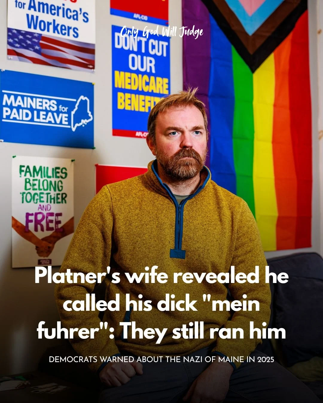 A man with a beard and mustache sitting in front of various political and pride flags on a wall. The wall includes a rainbow pride flag, a 'Mainers for Paid Leave' sign, a 'Don't Cut Our Medicare Benefits' sign, and a sign that says 'Families Belong 